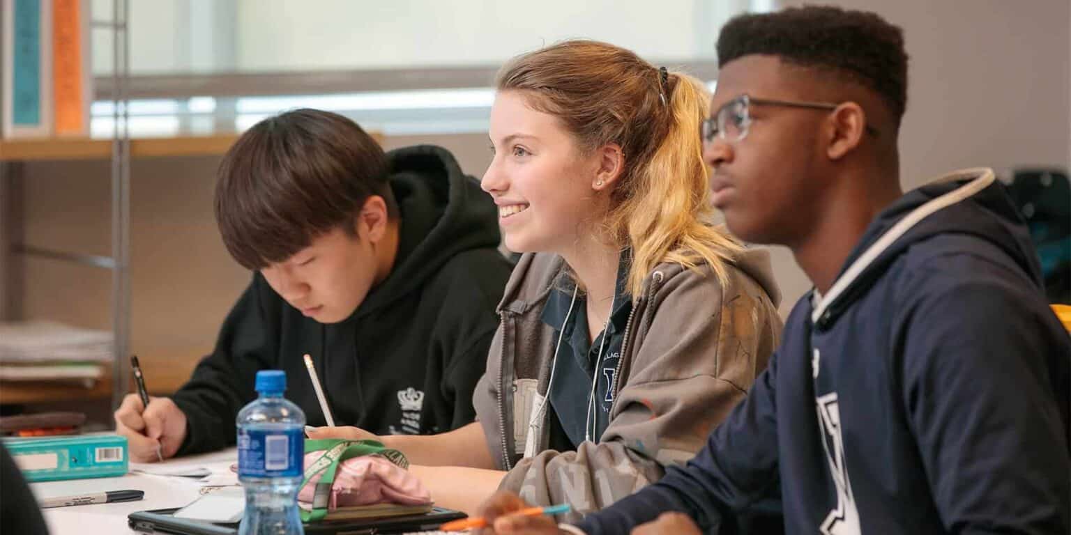 Students studying together in a modern classroom, representing world schools and international education opportunities.