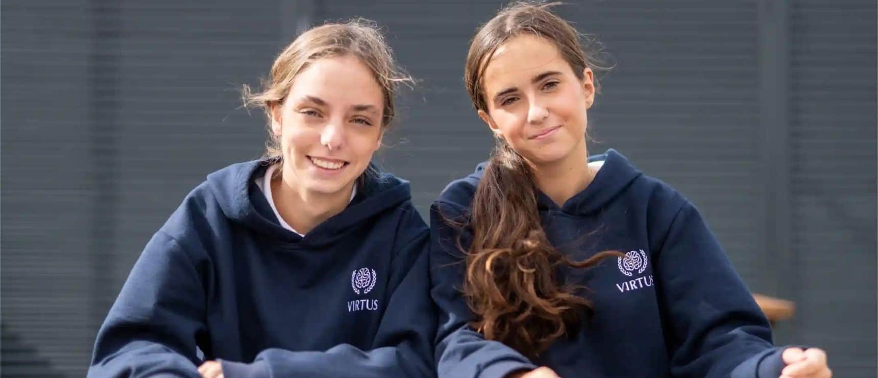 Bright students in school uniforms smiling at Virtus International School campus.