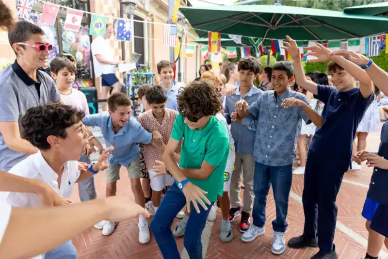 This Month at TASIS: June 2024 12 Vibrant international school students engaging in outdoor celebration, emphasizing global diversity and cultural exchange.
