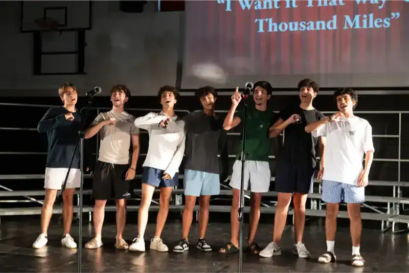 This Month at TASIS: June 2024 13 Young students performing on stage at World Schools event.