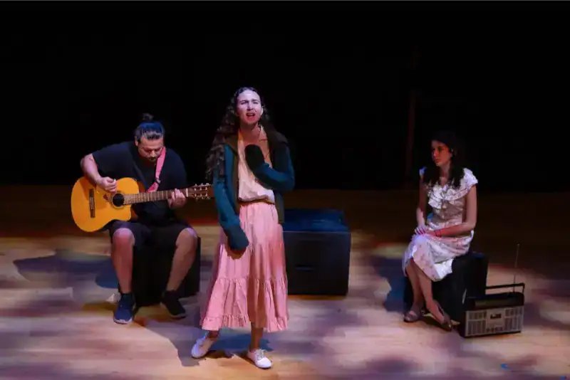 This Month at TASIS: June 2024 14 Young students performing music on stage at World Schools event.