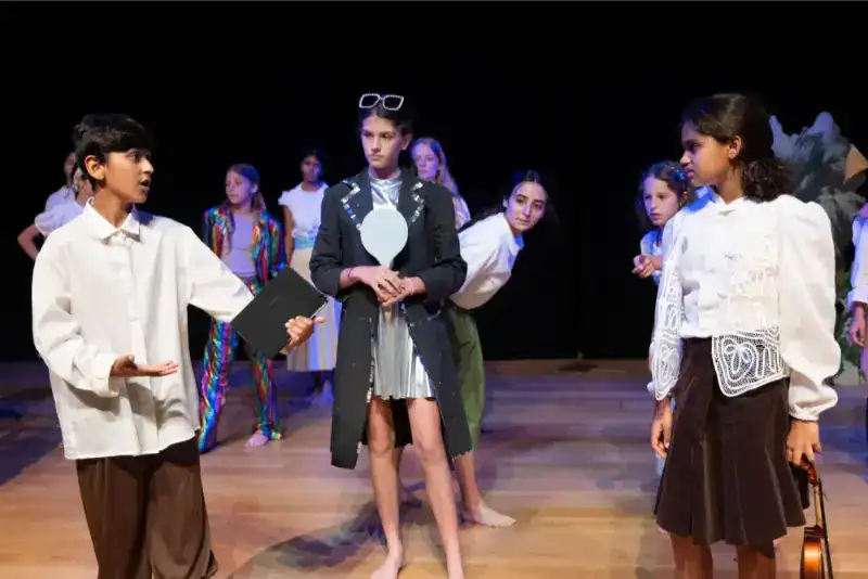 This Month at TASIS: June 2024 16 Diverse students participating in a school play at World Schools, highlighting international education and creative arts.