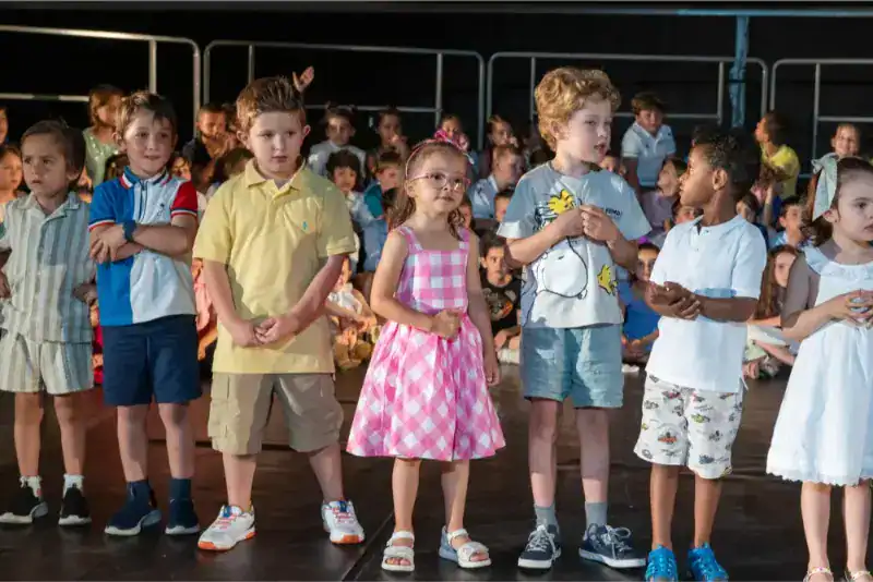 This Month at TASIS: June 2024 18 Children participating in a school event at a World Schools location, showcasing diverse students and engaging activities.