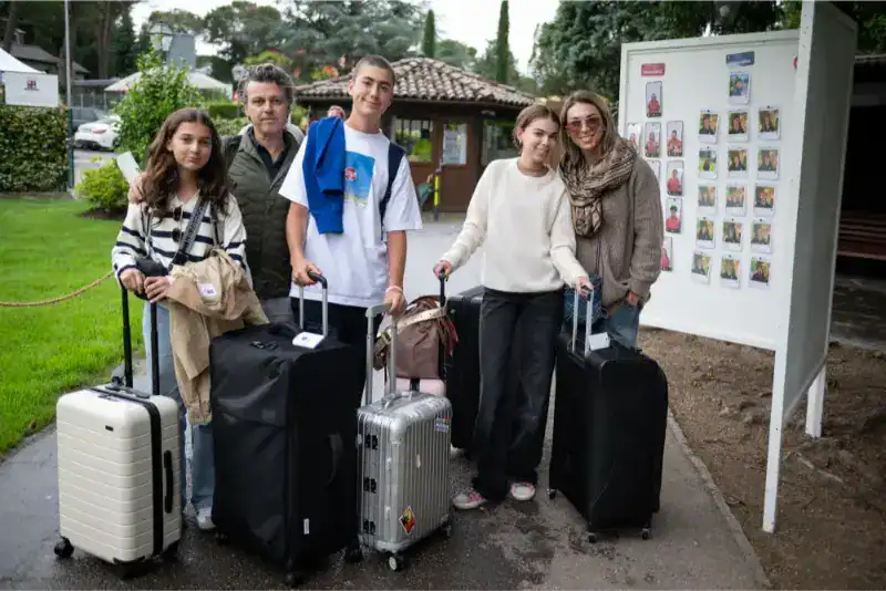 This Month at TASIS: June 2024 1 Modern international students arriving at a world schools campus with luggage.