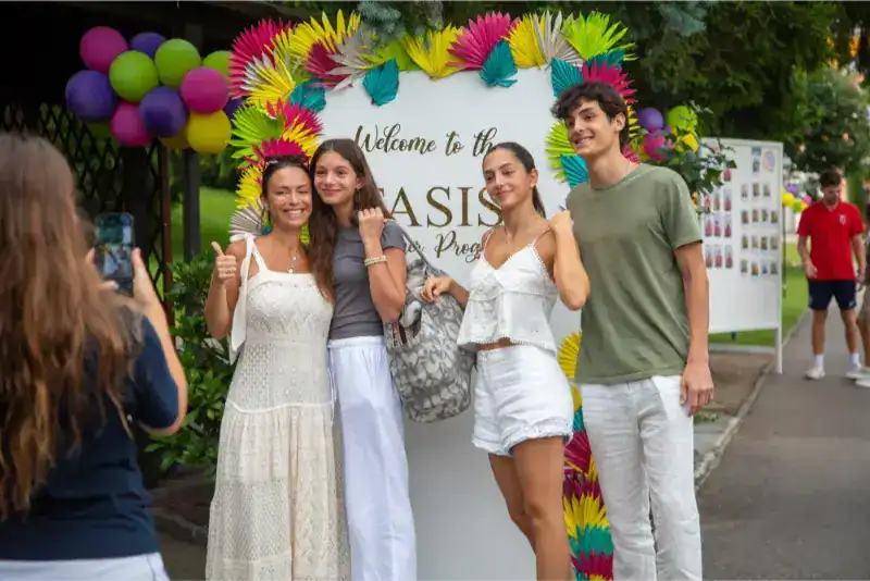 This Month at TASIS: June 2024 20 Vibrant group of students taking photos at World Schools Oasis event, showcasing international education and diverse student community.