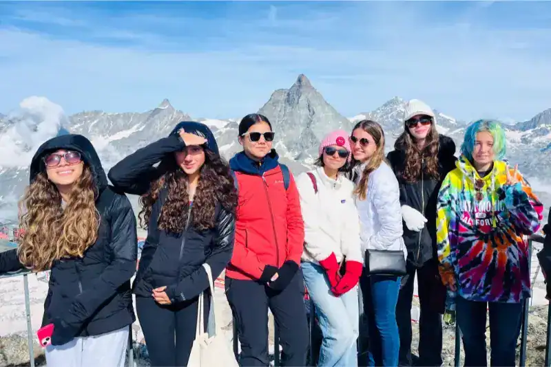 This Month at TASIS: June 2024 33 Sunshine school group enjoying mountains, showcasing international student travel and outdoor education experiences.