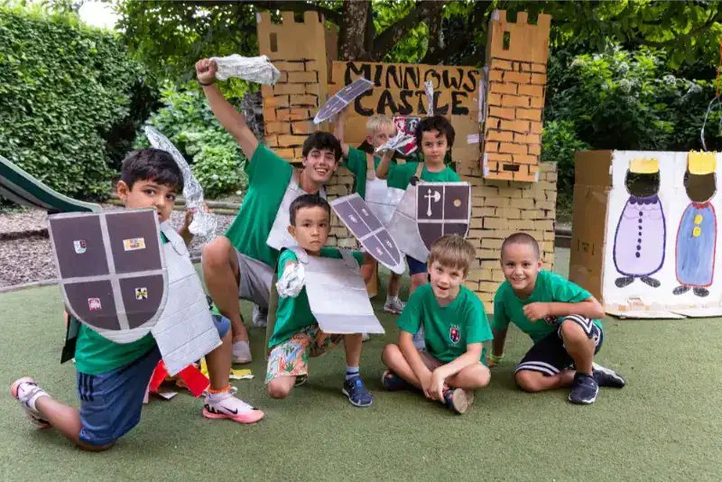 This Month at TASIS: June 2024 37 Colorful children enjoying medieval castle-themed dress-up activity at a summer camp.