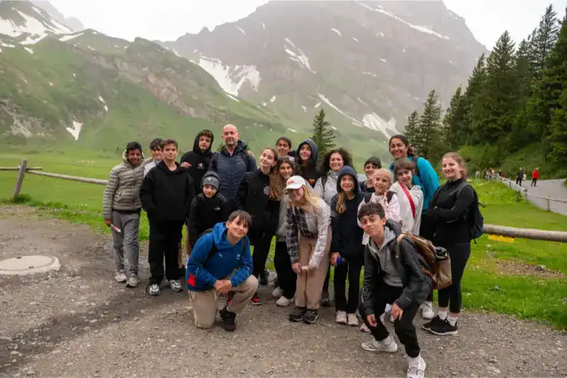 This Month at TASIS: June 2024 6 Students and teachers on a school trip in scenic mountain landscape for global education.