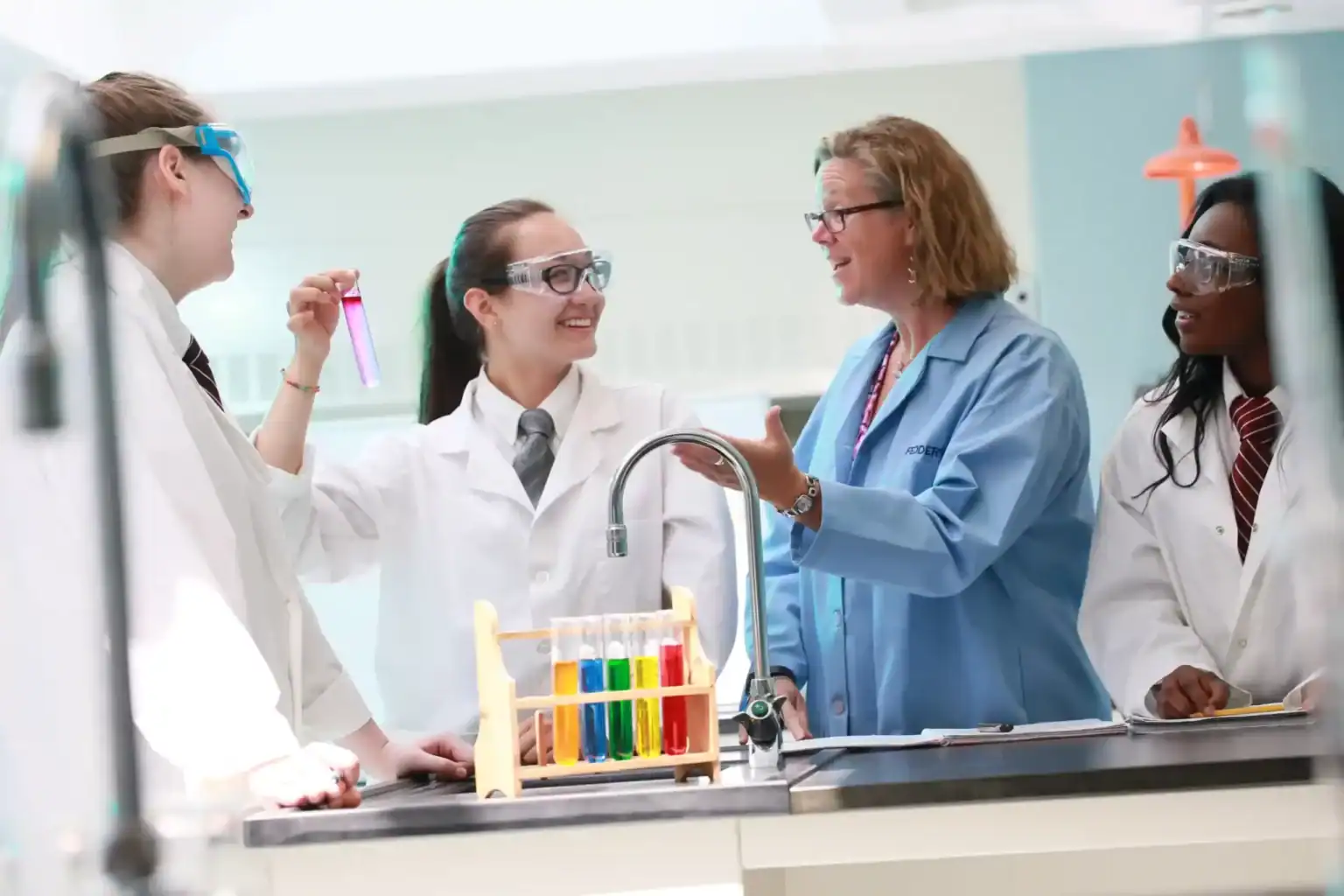 Innovative science classroom with diverse students and teacher engaging in hands-on experiments.