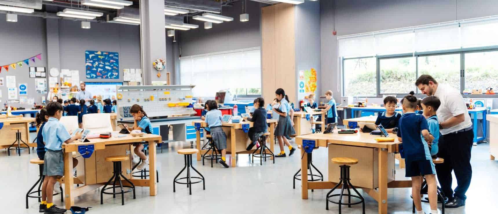 Modern classroom with young students using tablets for interactive learning at a World Schools educational center.