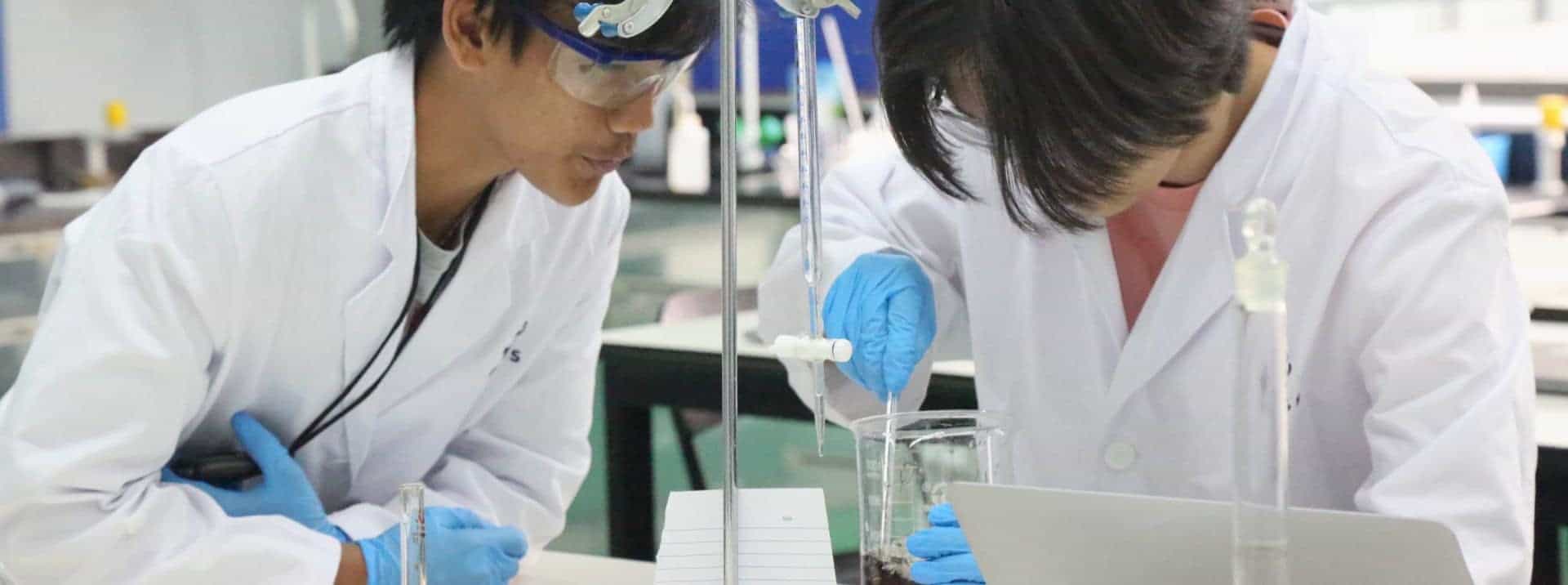 Bright students conducting scientific experiment in innovative world schools science lab.