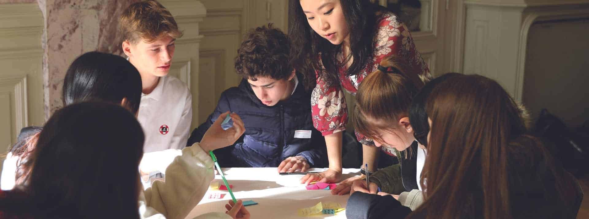 Diverse students collaborating on a group project at a world school, fostering global education and teamwork.