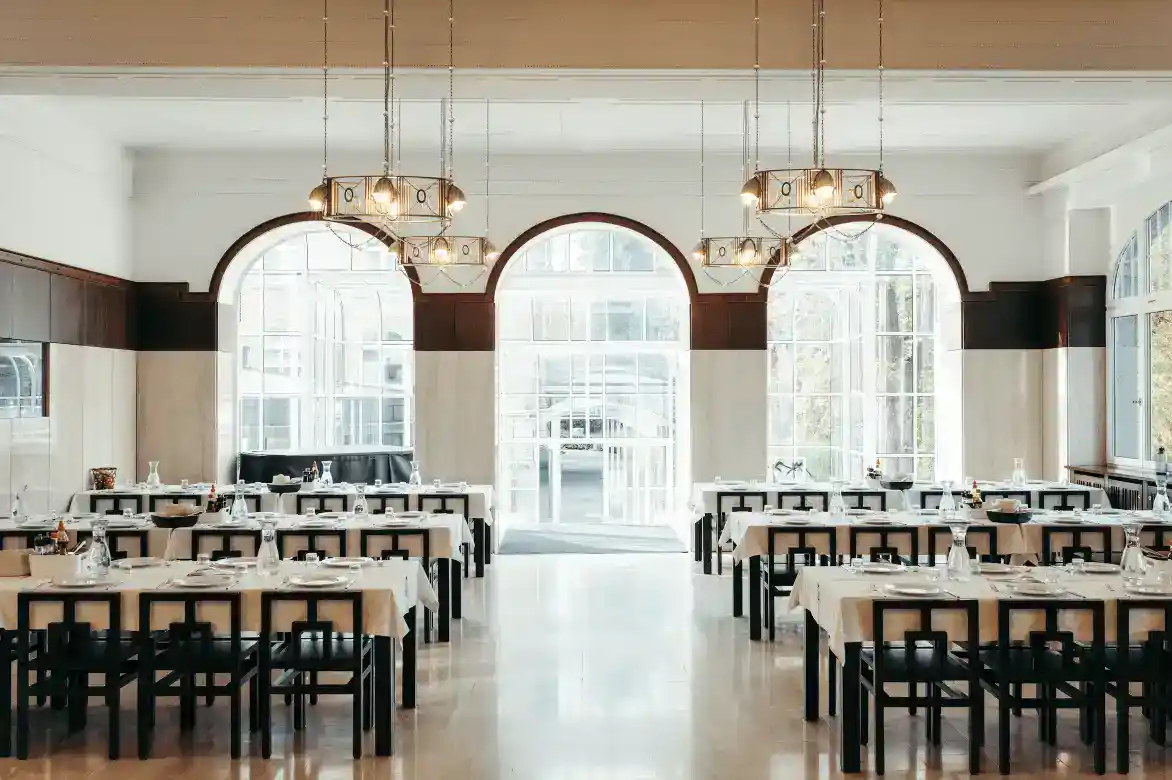 Bright dining hall at an elite international school with elegant decor and large windows, perfect for student meals.