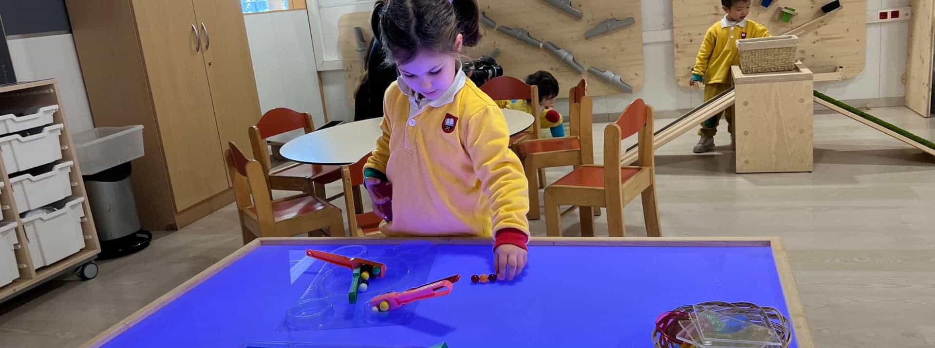 Bright preschool classroom with children engaging in educational activities at World Schools.