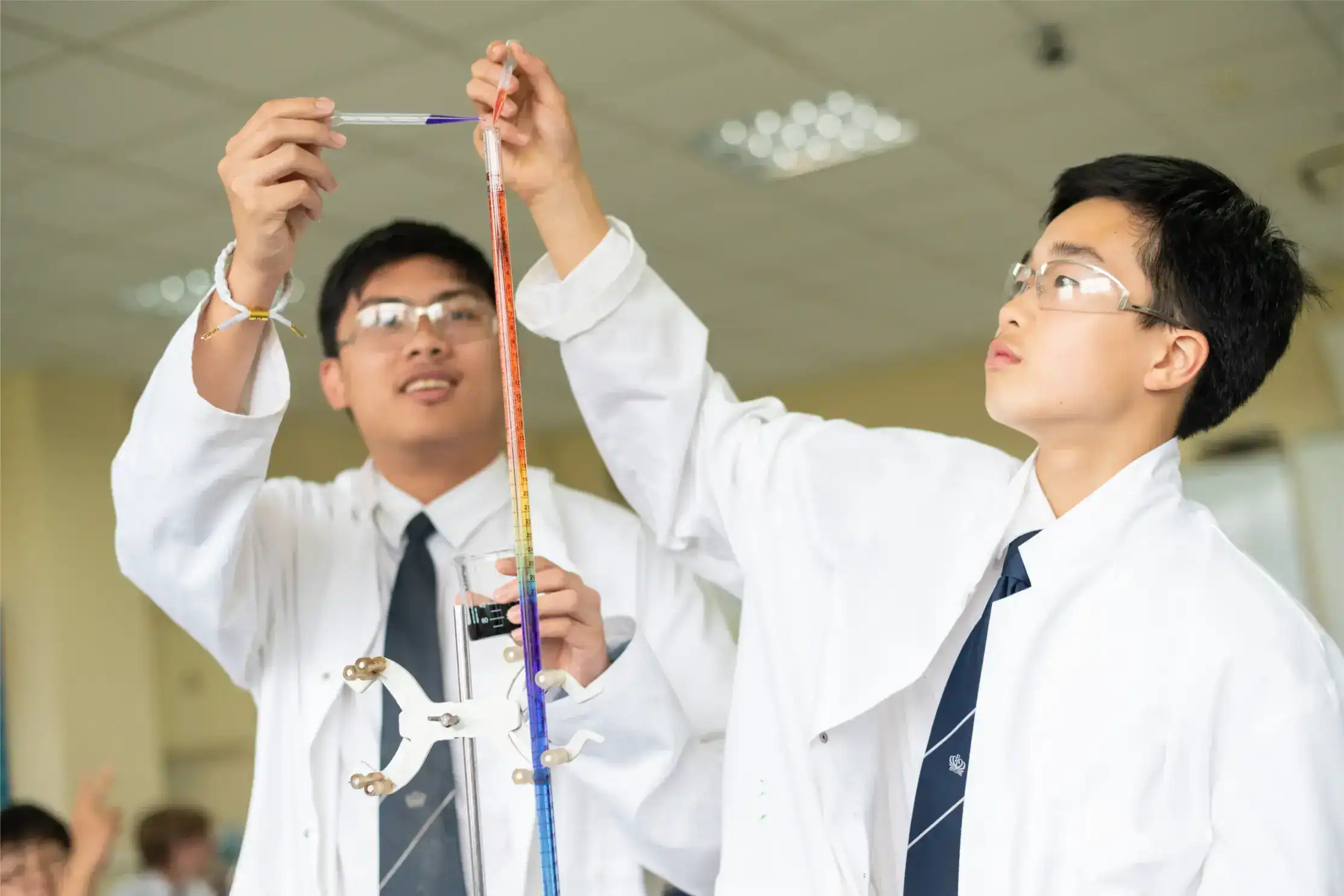 Students conducting science experiments in a classroom at a world-famous school, emphasizing STEM education and innovative learning.