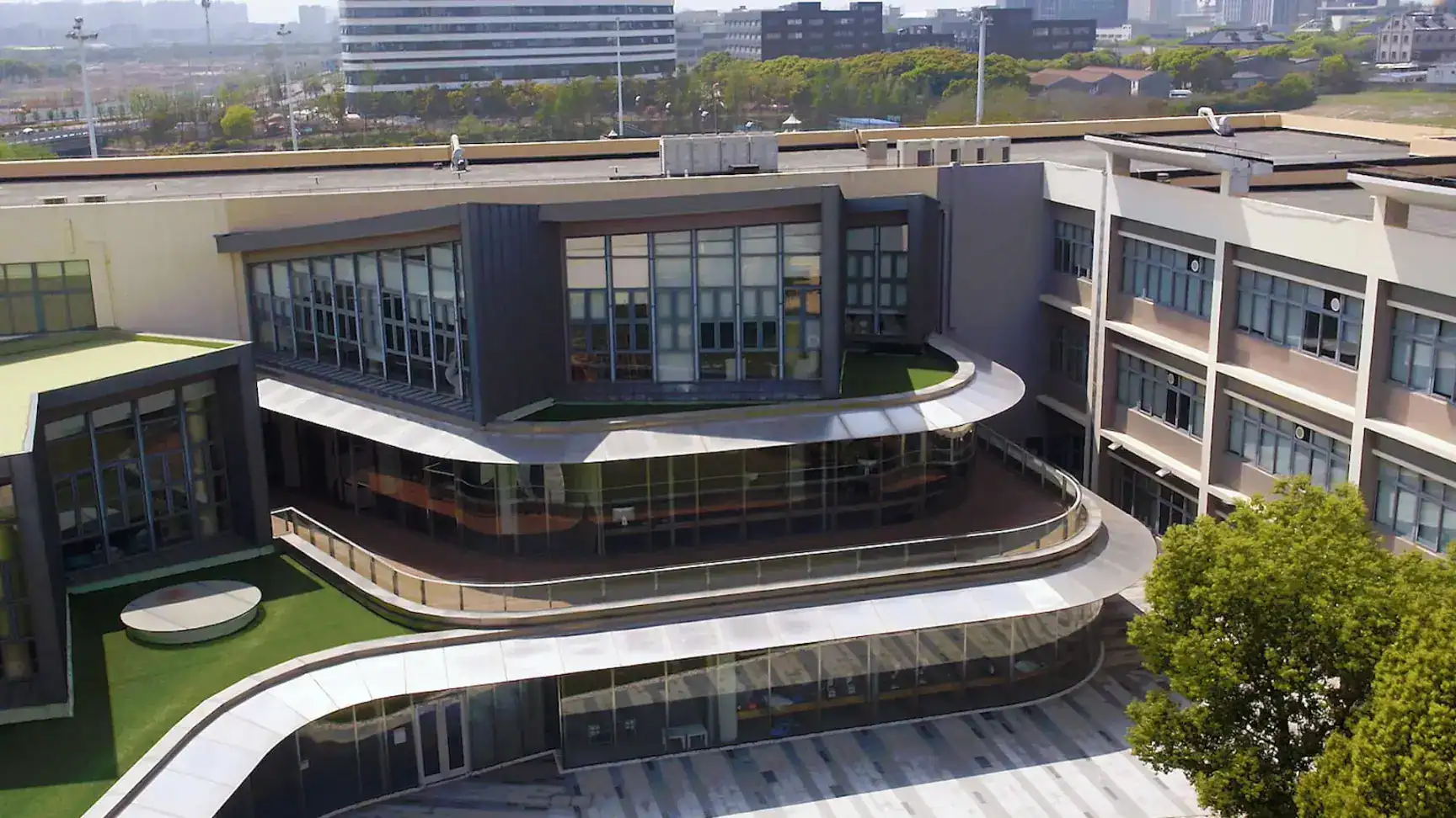 Modern educational campus with innovative architecture and green outdoor spaces.
