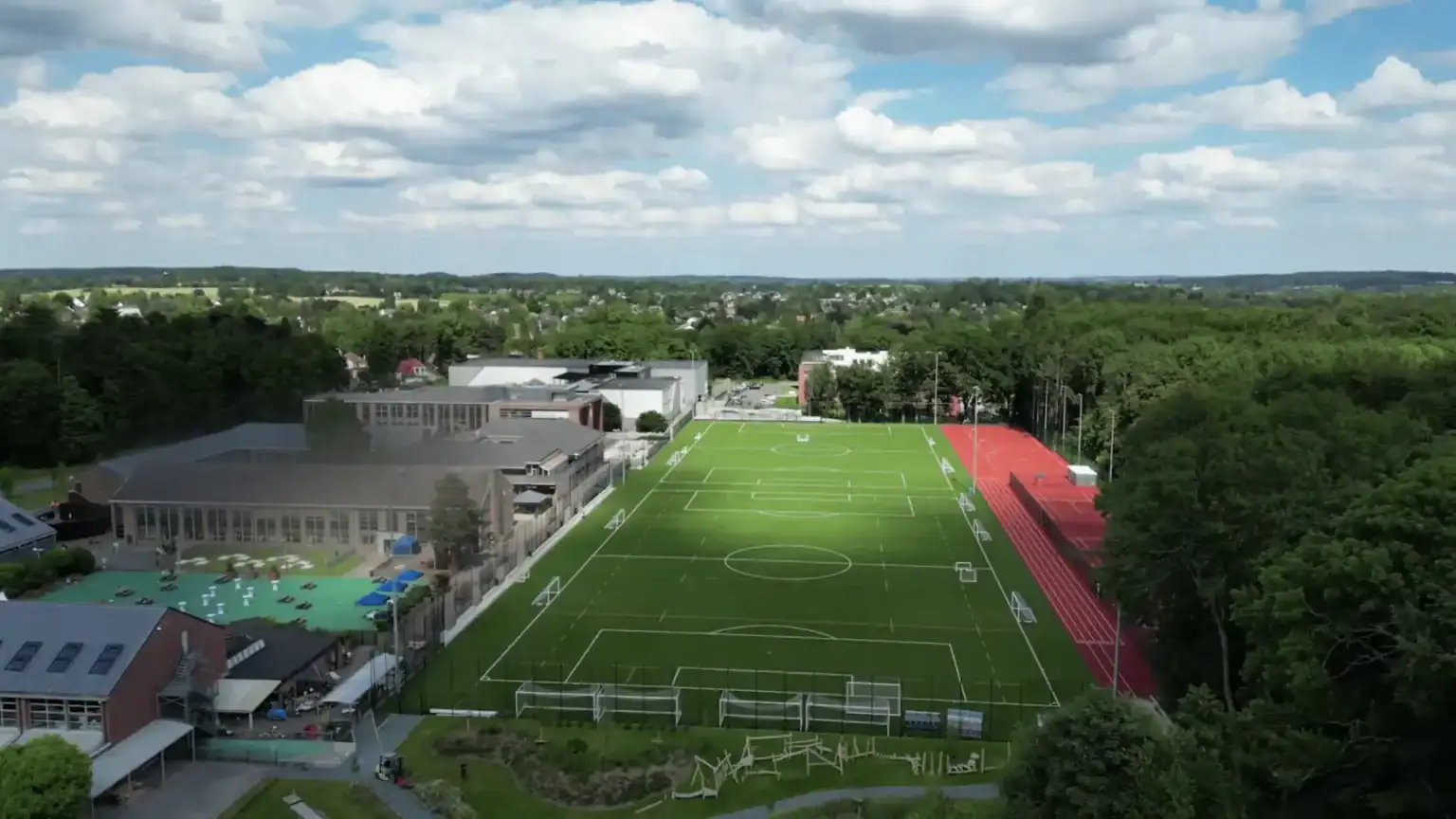 Modern school sports field and facilities at a top international school campus.