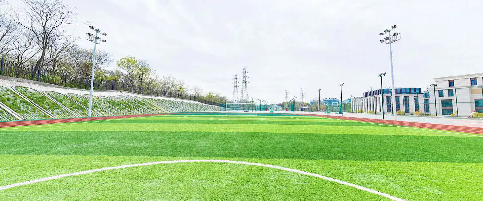 Bright sports field at World Schools campus with modern facilities and green surroundings.