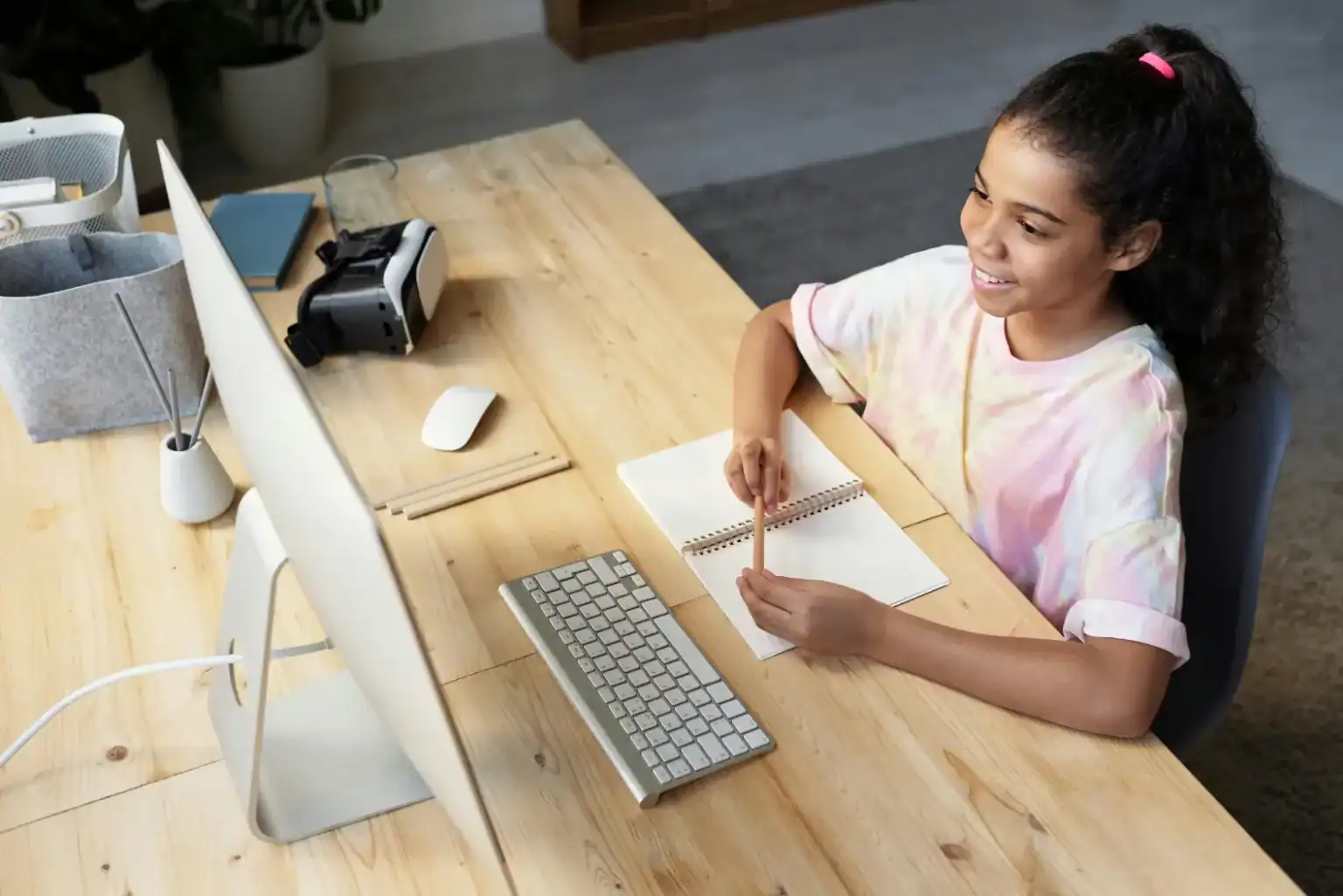 Young girl using computer for online learning at home, educational digital tools, remote schooling, children education, virtual learning, student studying online, innovative education.