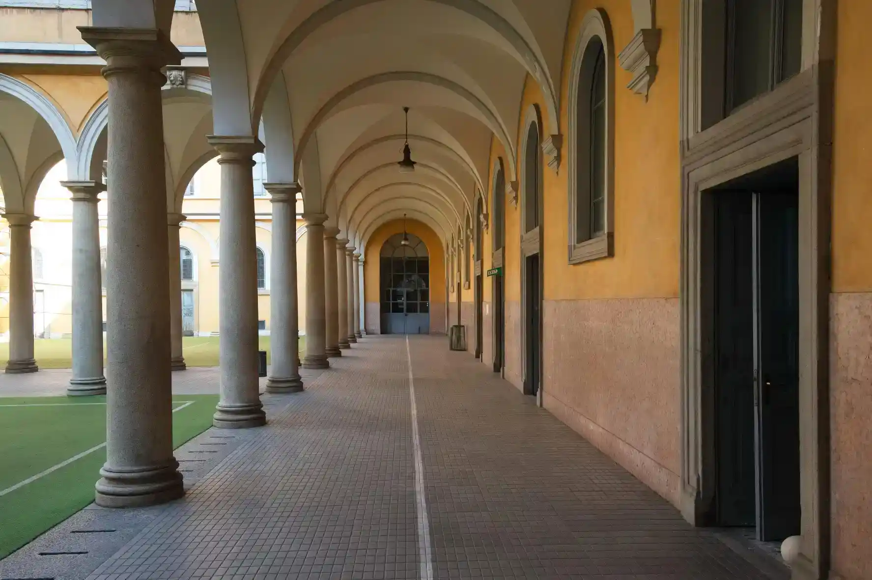 Elegant school corridor with classic architecture and arched windows, ideal for global learning environments.