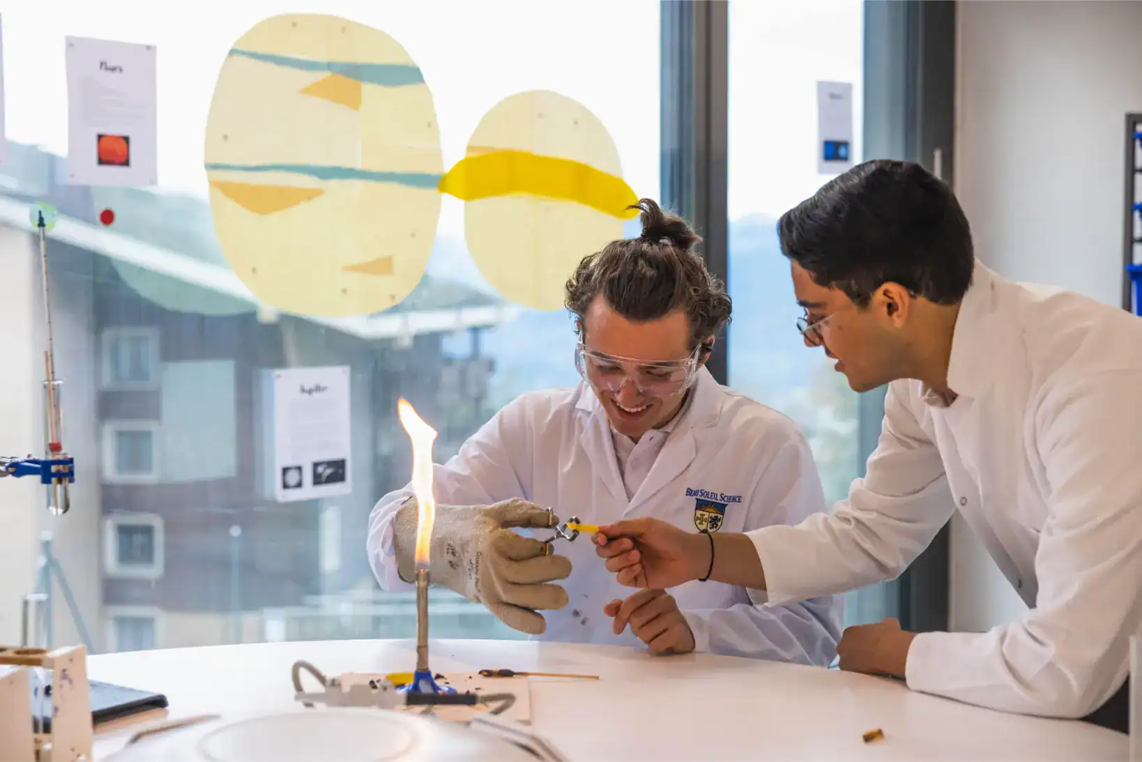 Students conducting a science experiment in a modern classroom, practicing hands-on science at a world school.