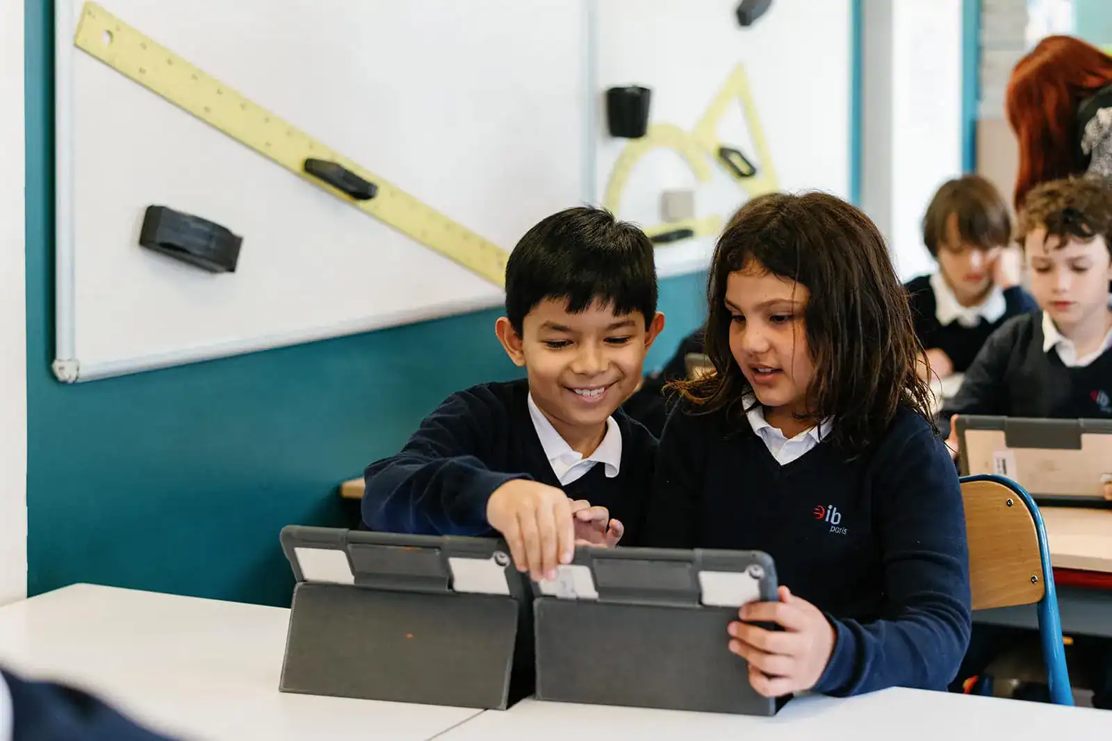 Engaging students using tablets in a modern classroom setting for innovative education.