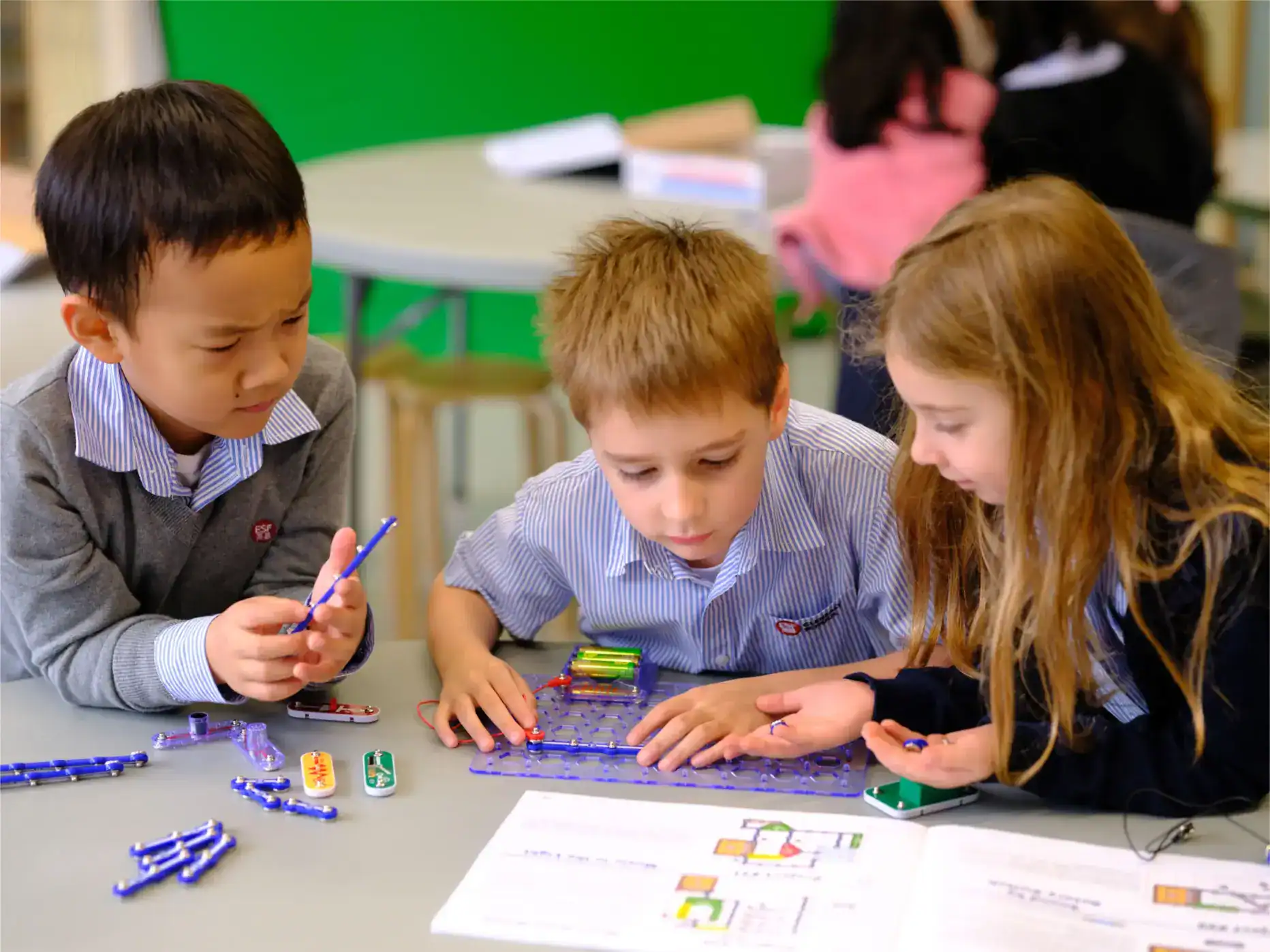 Children engaged in hands-on STEM activities at a World Schools classroom, fostering creativity and collaborative learning.
