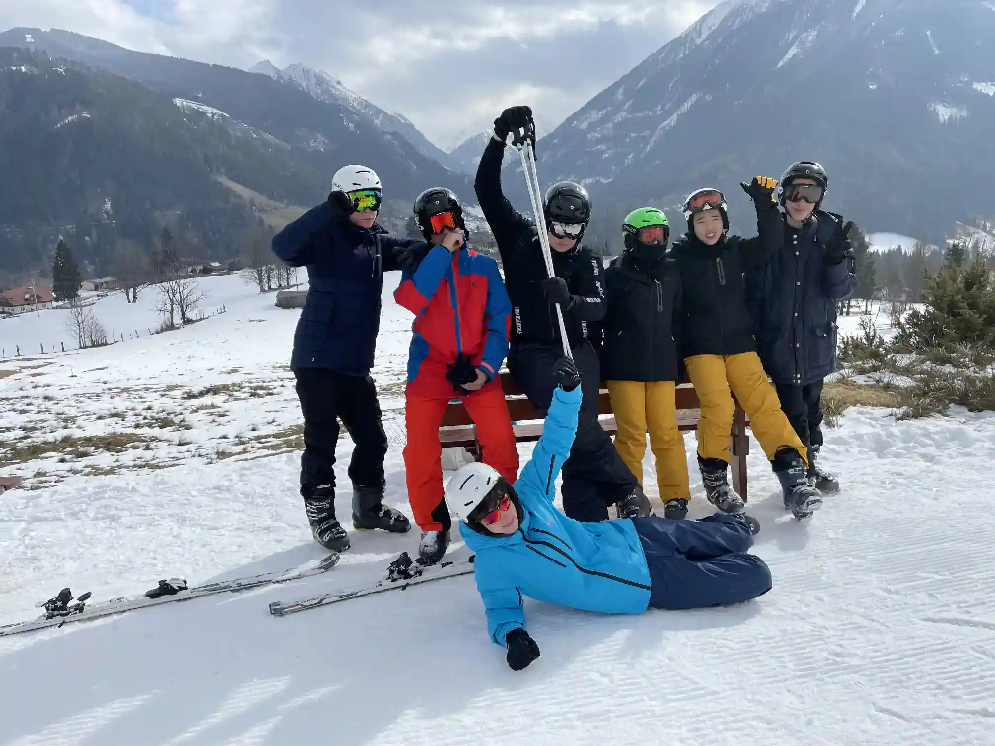 Active students enjoying winter skiing in scenic mountain landscape at a world school.