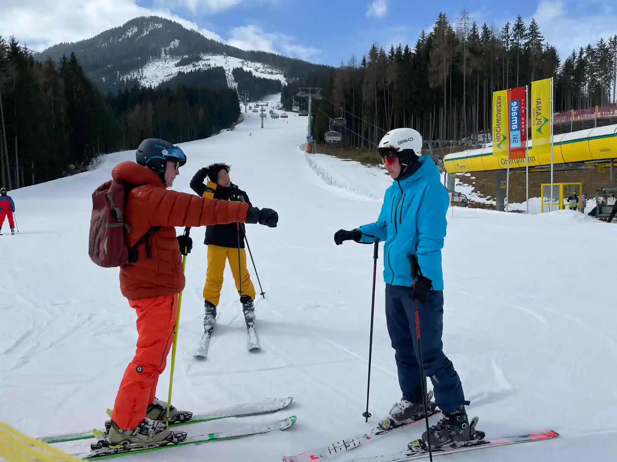 Skier instructor giving guidance on snowy mountain ski slopes with students at World Schools.