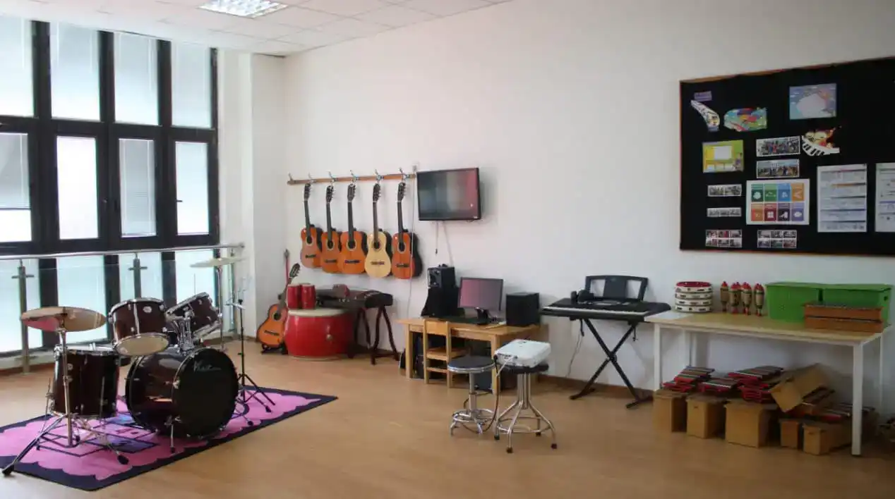 Colorful music room with guitars, drums, and musical instruments at World Schools.