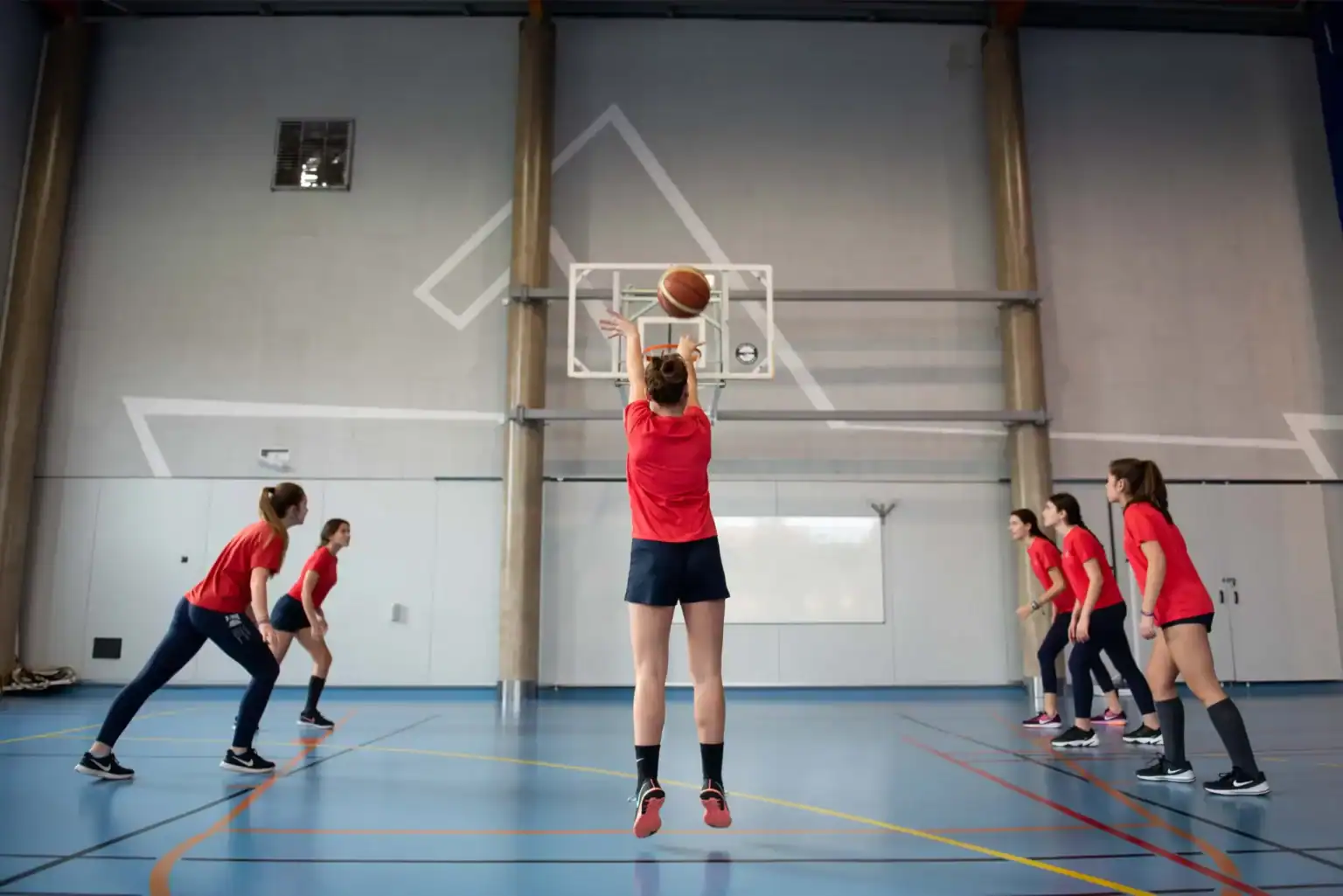 Basketball training at a world school indoor sports facility.