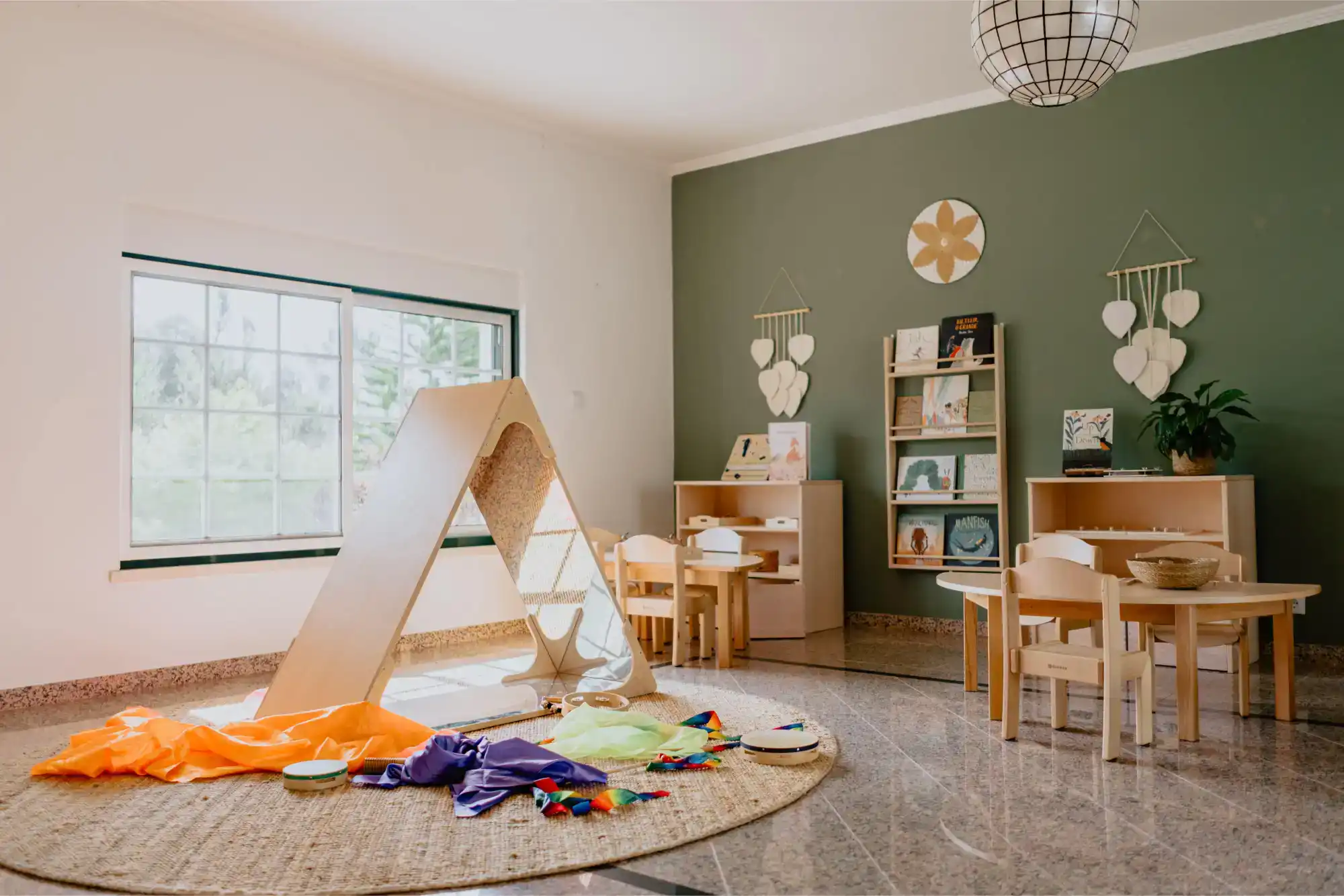Bright preschool classroom with wooden furniture and educational toys for early childhood learning.