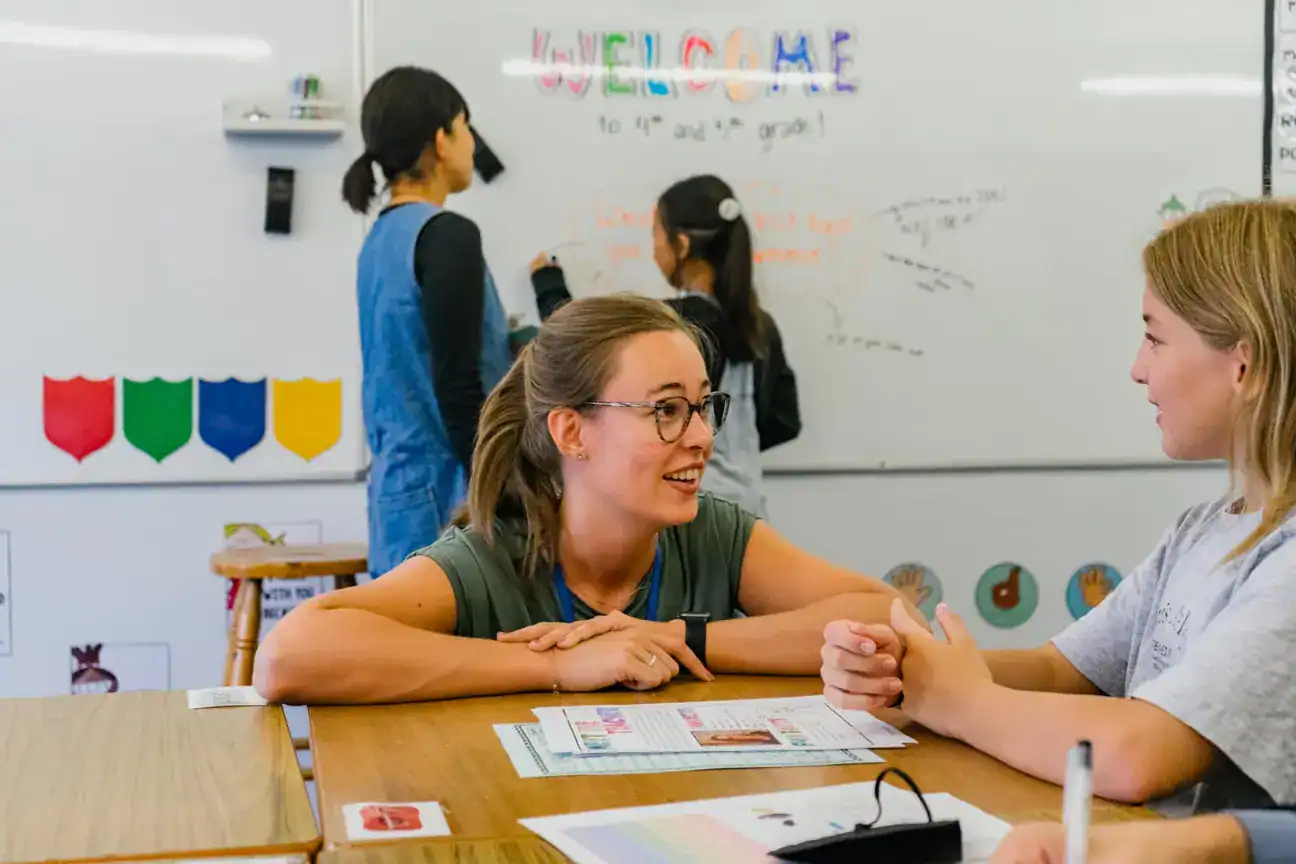Meeting of a teacher and student in an international school classroom in the United States.