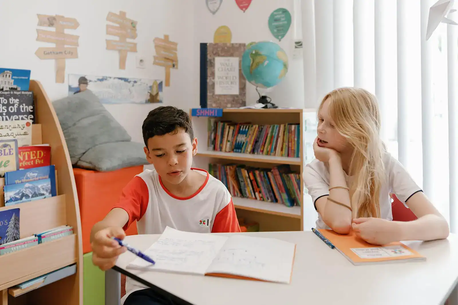 Young students studying together in a vibrant classroom, promoting international education and global learning at World Schools.