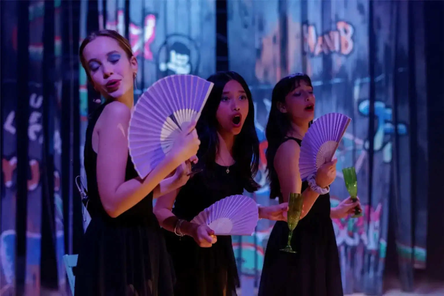 Vibrant girls performing arts act in a colorful theatrical scene at a world school event.