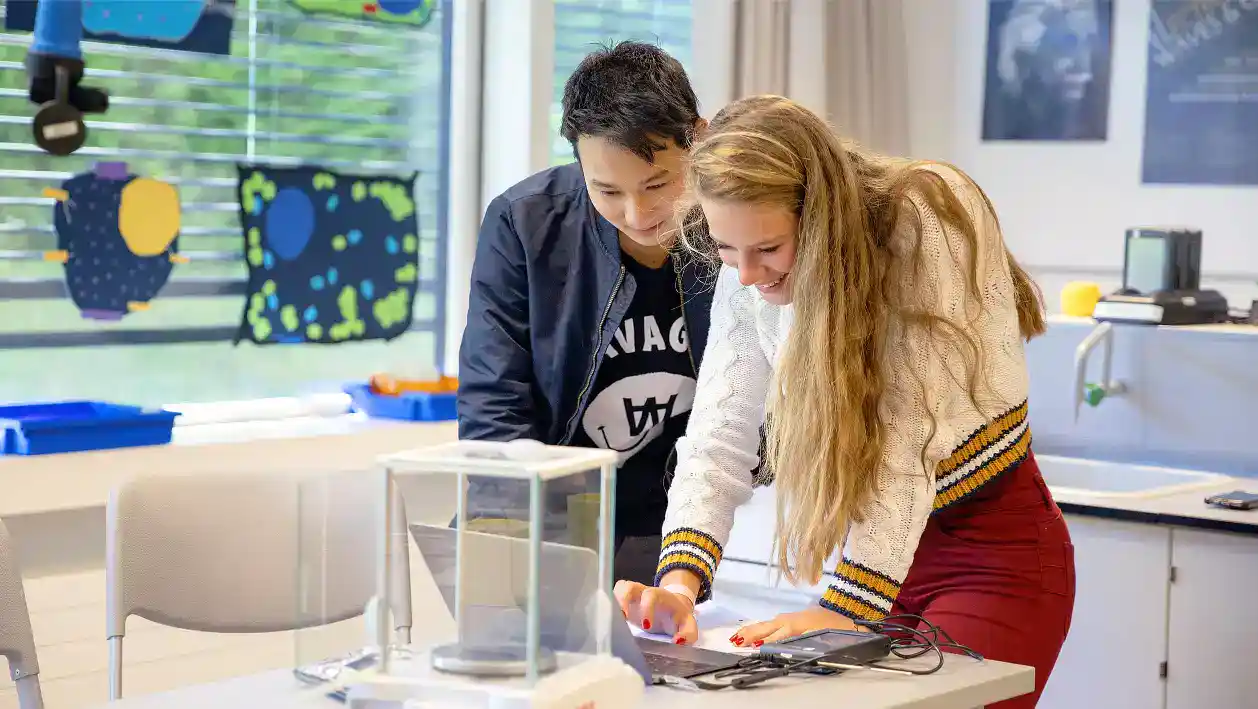 Bright students collaborating on STEM project in a modern classroom, emphasizing innovative education.