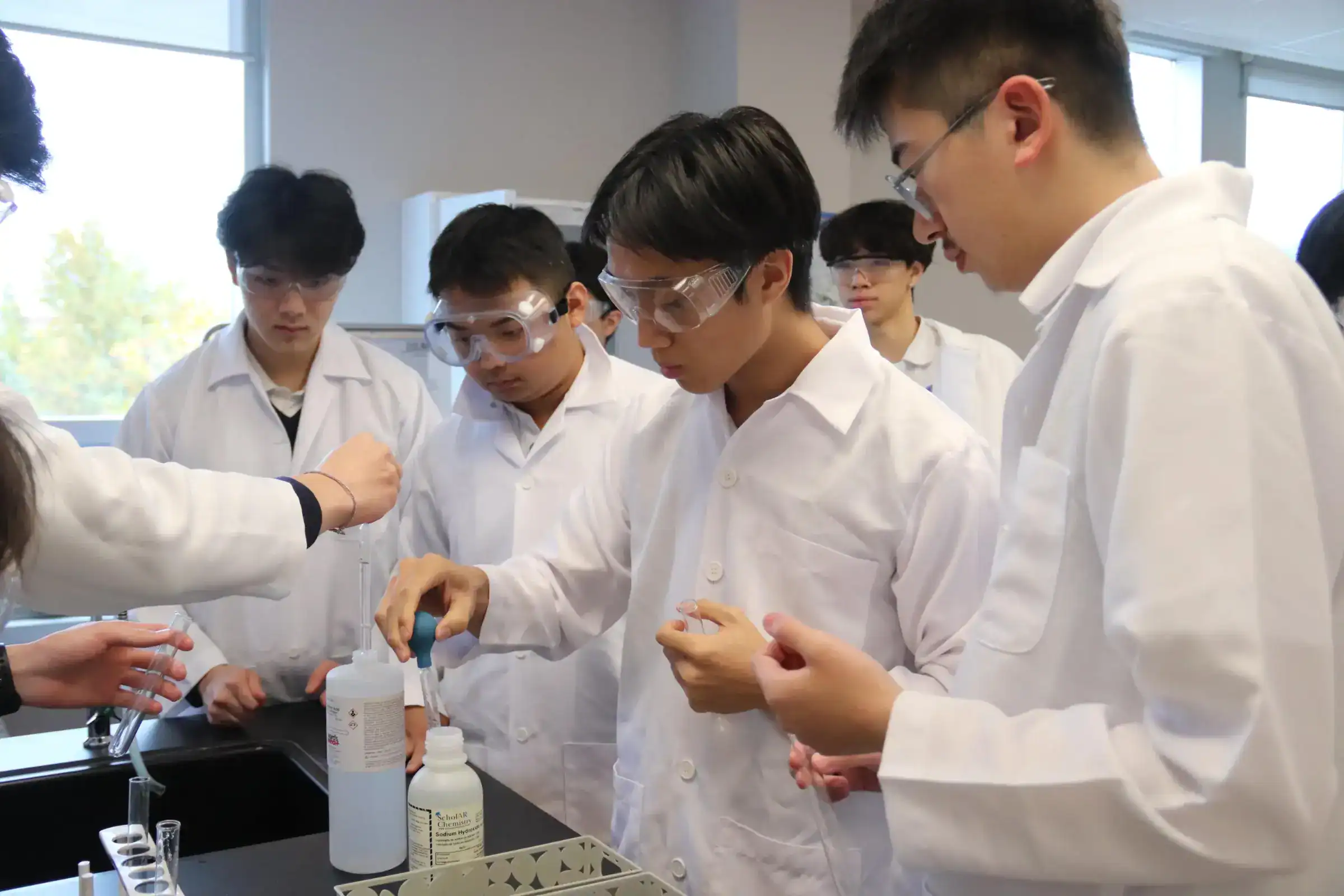 Students conducting science experiments in a modern classroom at a world school.