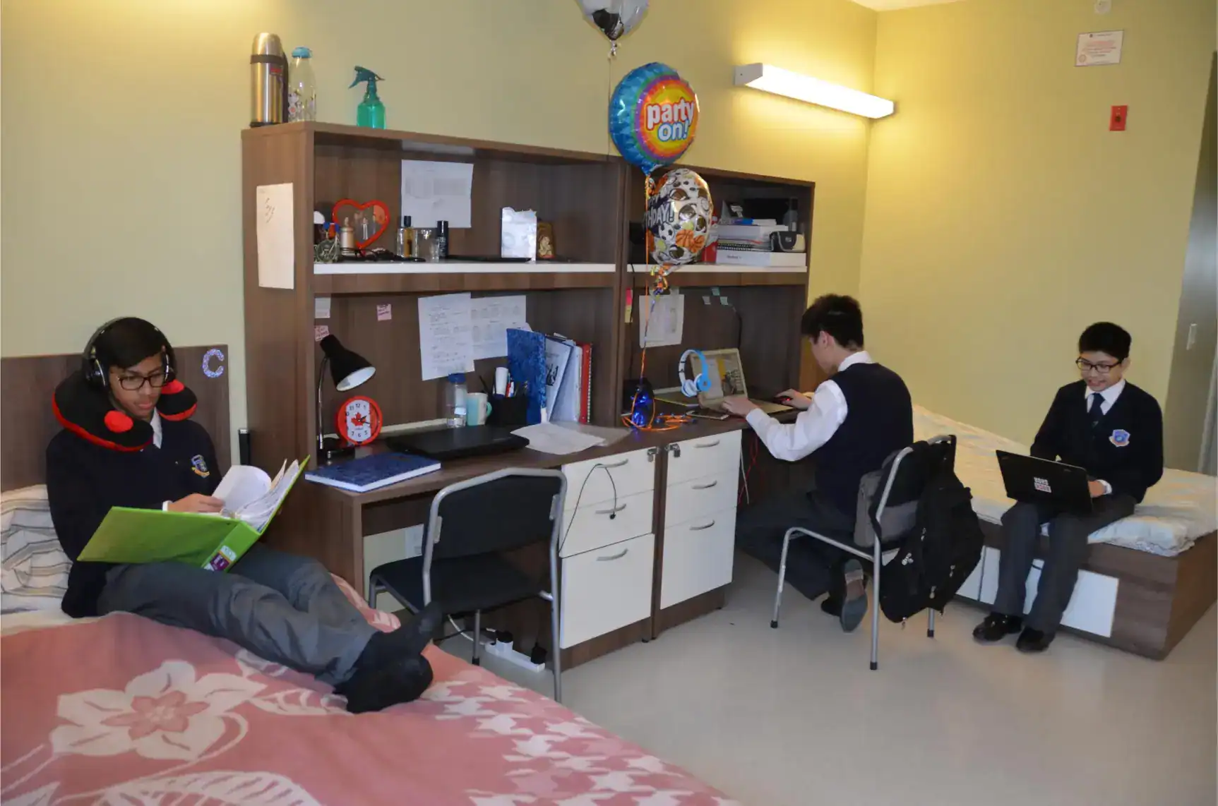 Students studying and doing homework in a cozy dorm room at a World School.