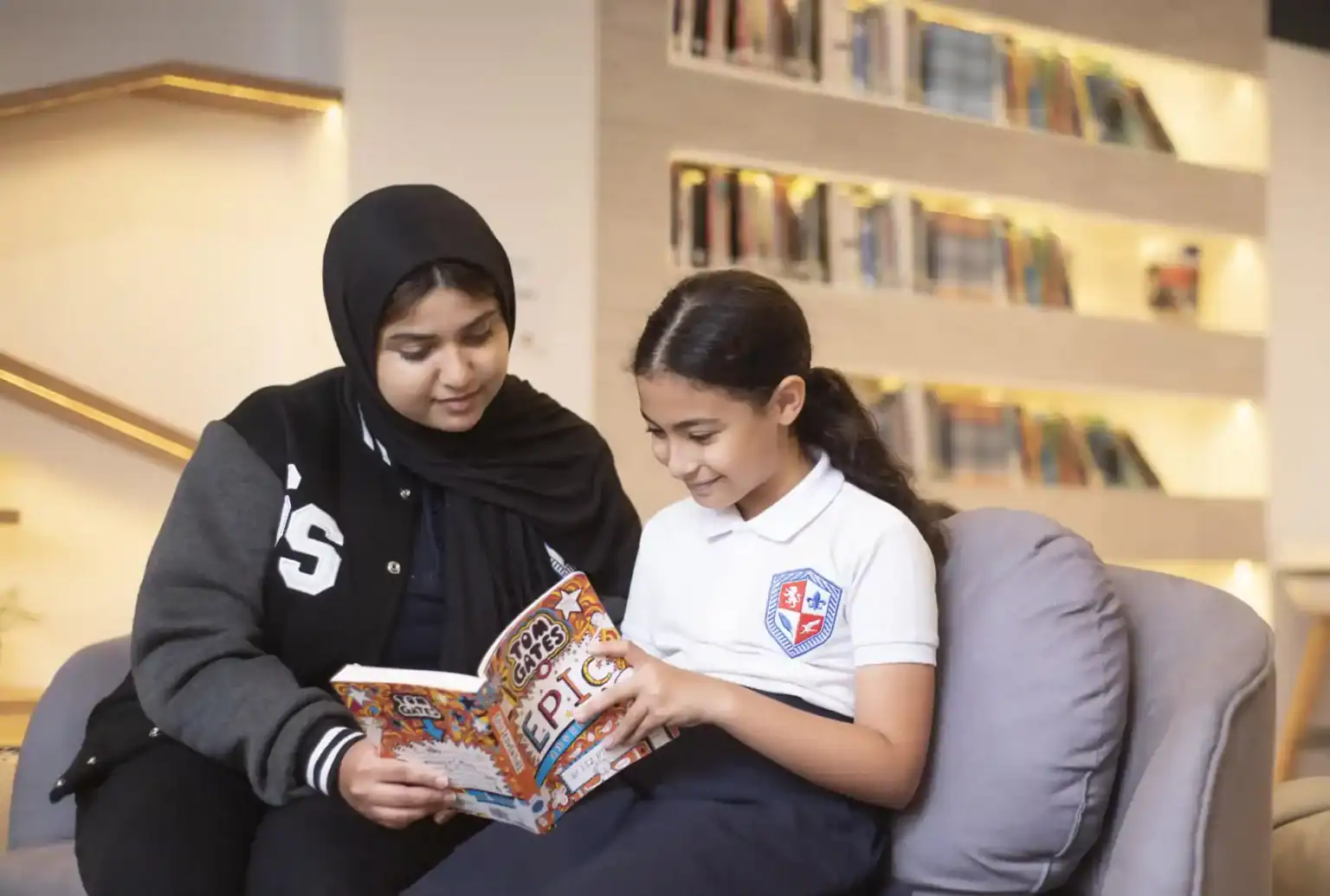 Children reading in a modern library, emphasizing world schools with diverse student communities and excellent educational facilities.