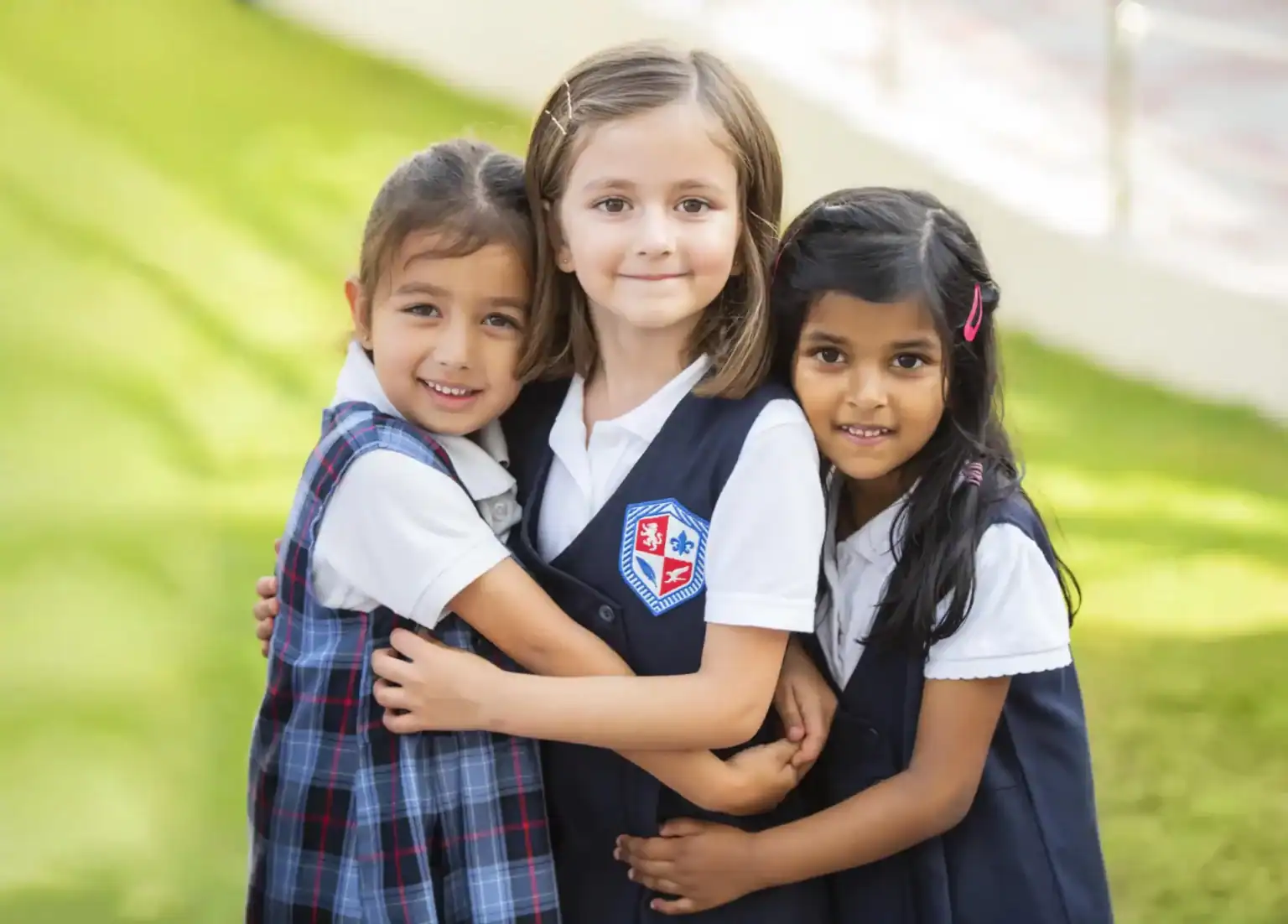 Friendly diverse schoolchildren embracing outdoors for Global Education and International School community.