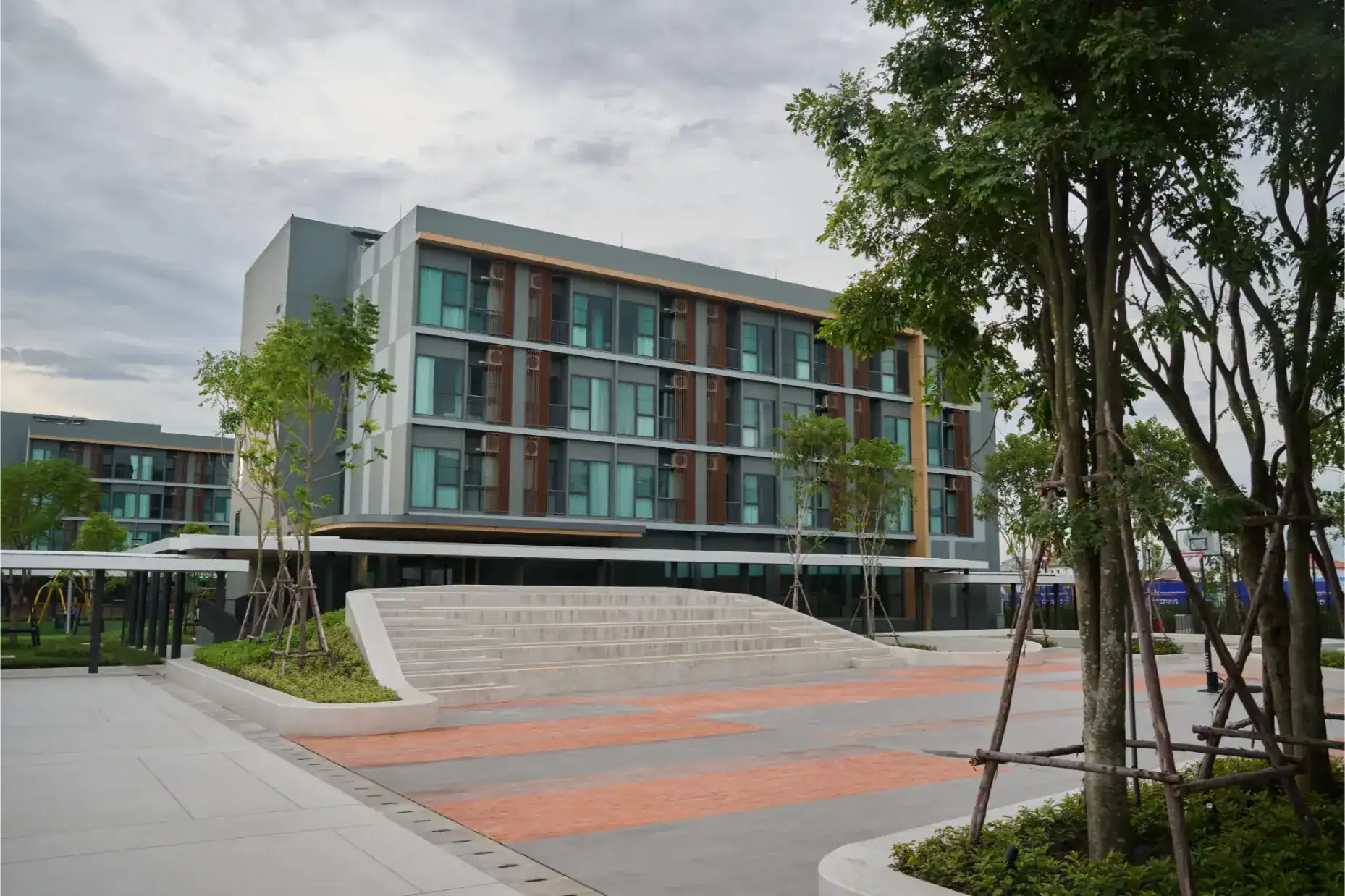 Modern school building with greenery, designed for international education and global learning.