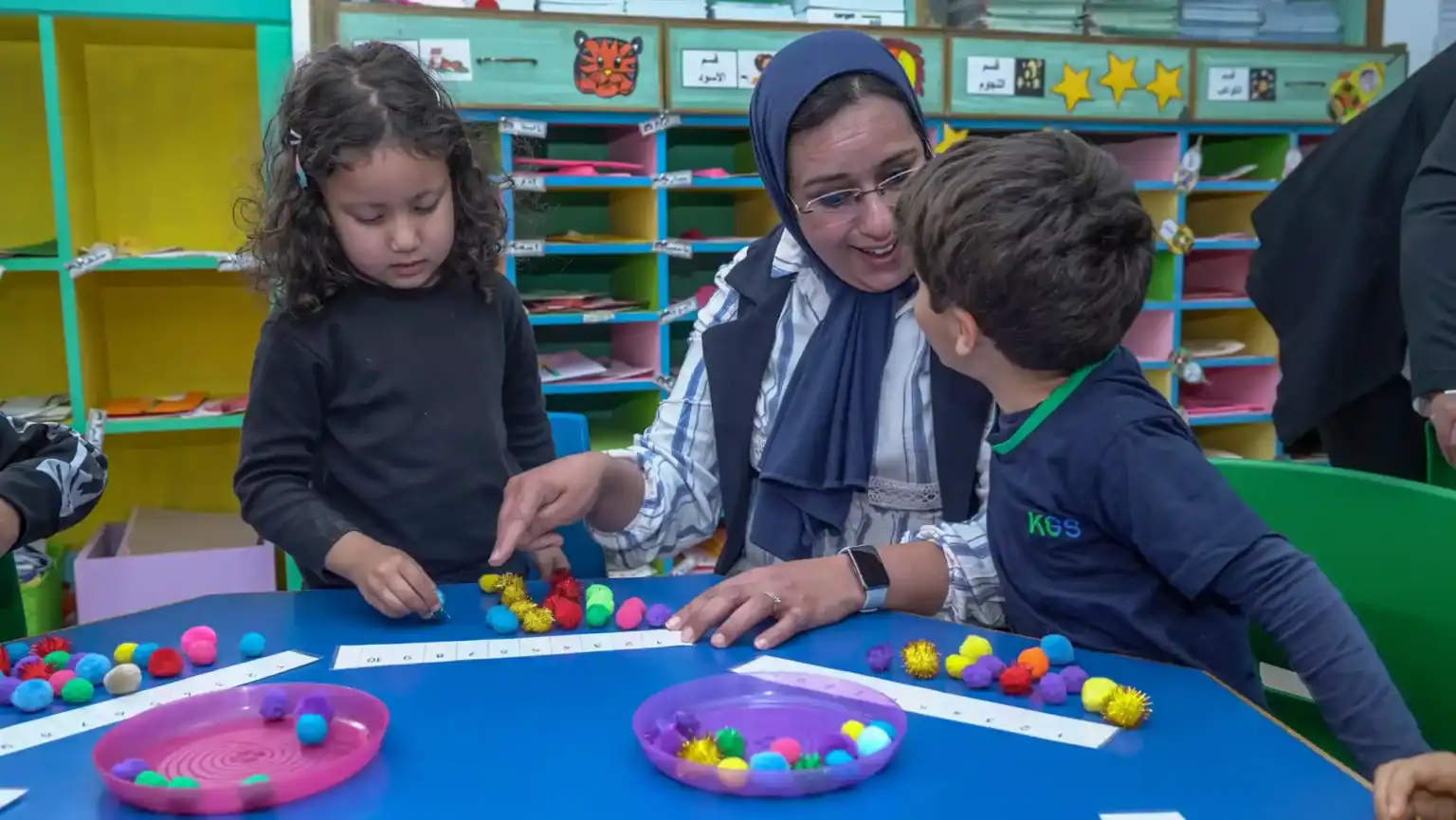 Colorful educational activity with young students and teacher in a vibrant classroom environment.