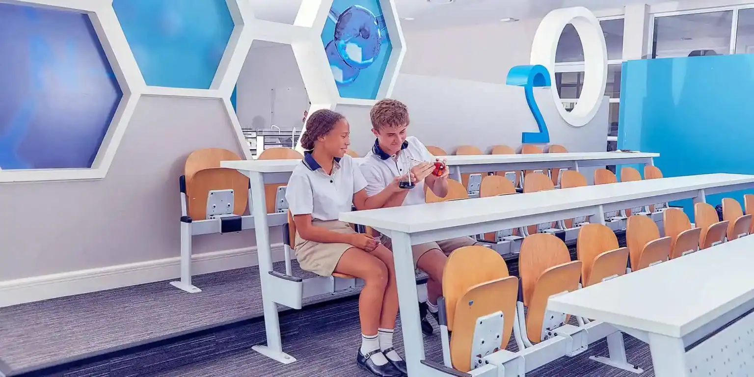 Bright modern classroom at World Schools with students conducting science experiments, fostering innovative learning.
