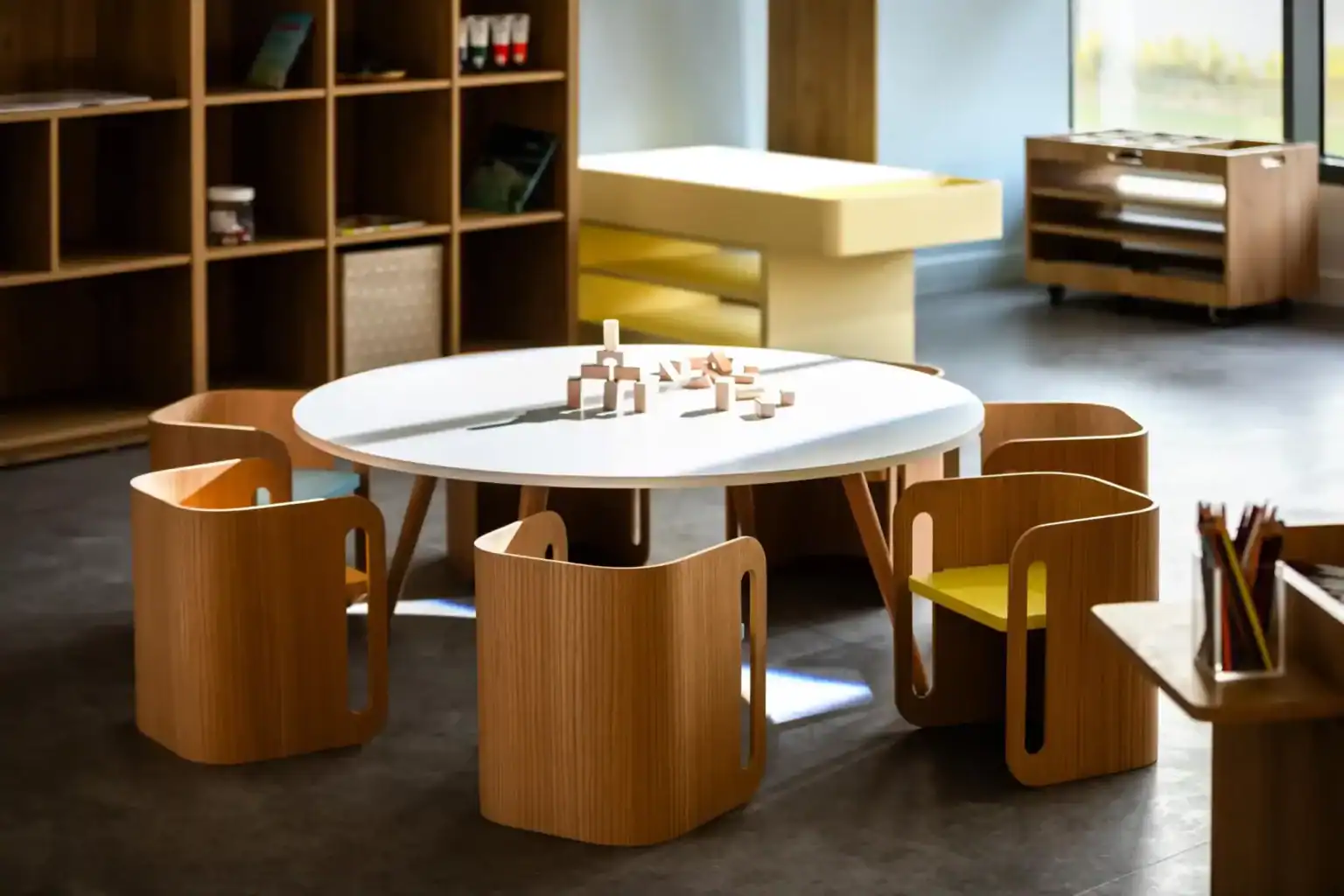 Bright modern classroom with child-friendly furniture and educational toys for young learners.