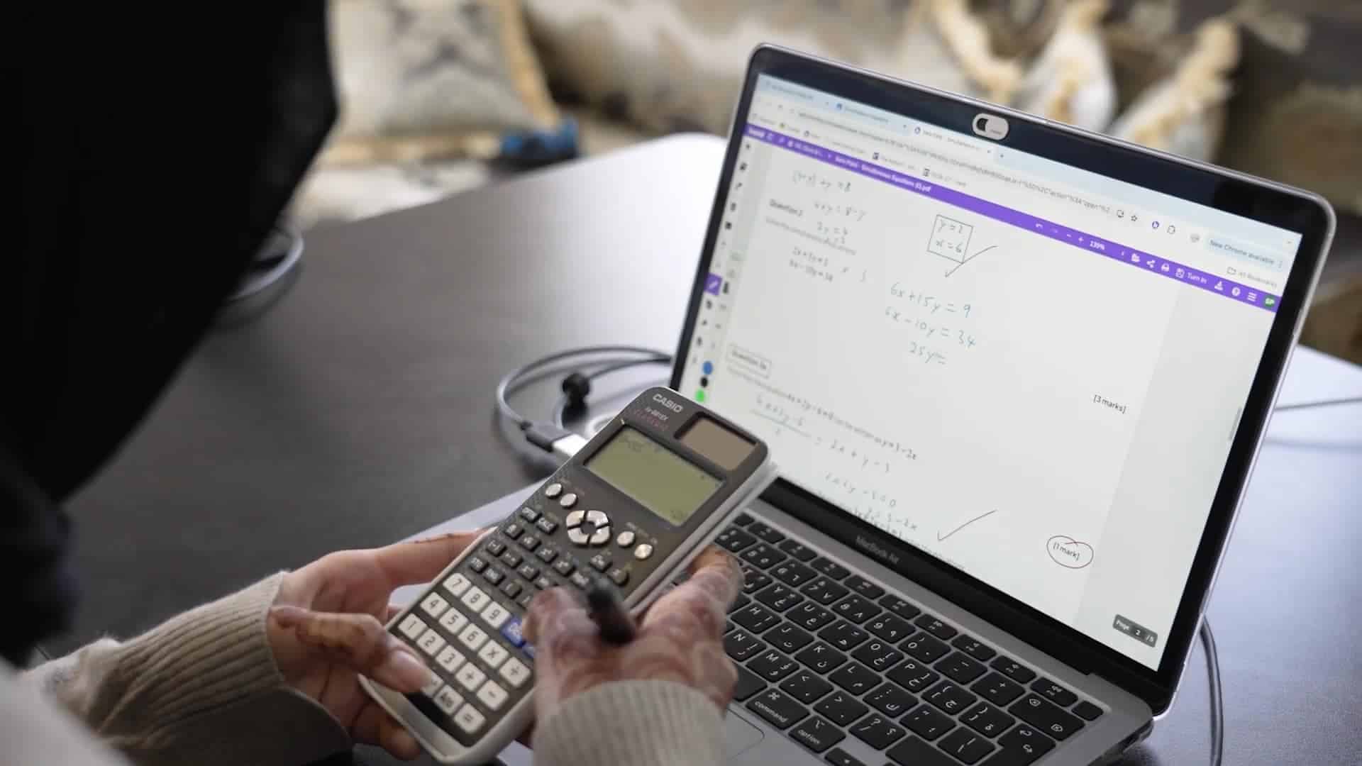 Online math class with digital tools, calculator, and laptop for remote learning at a world school.