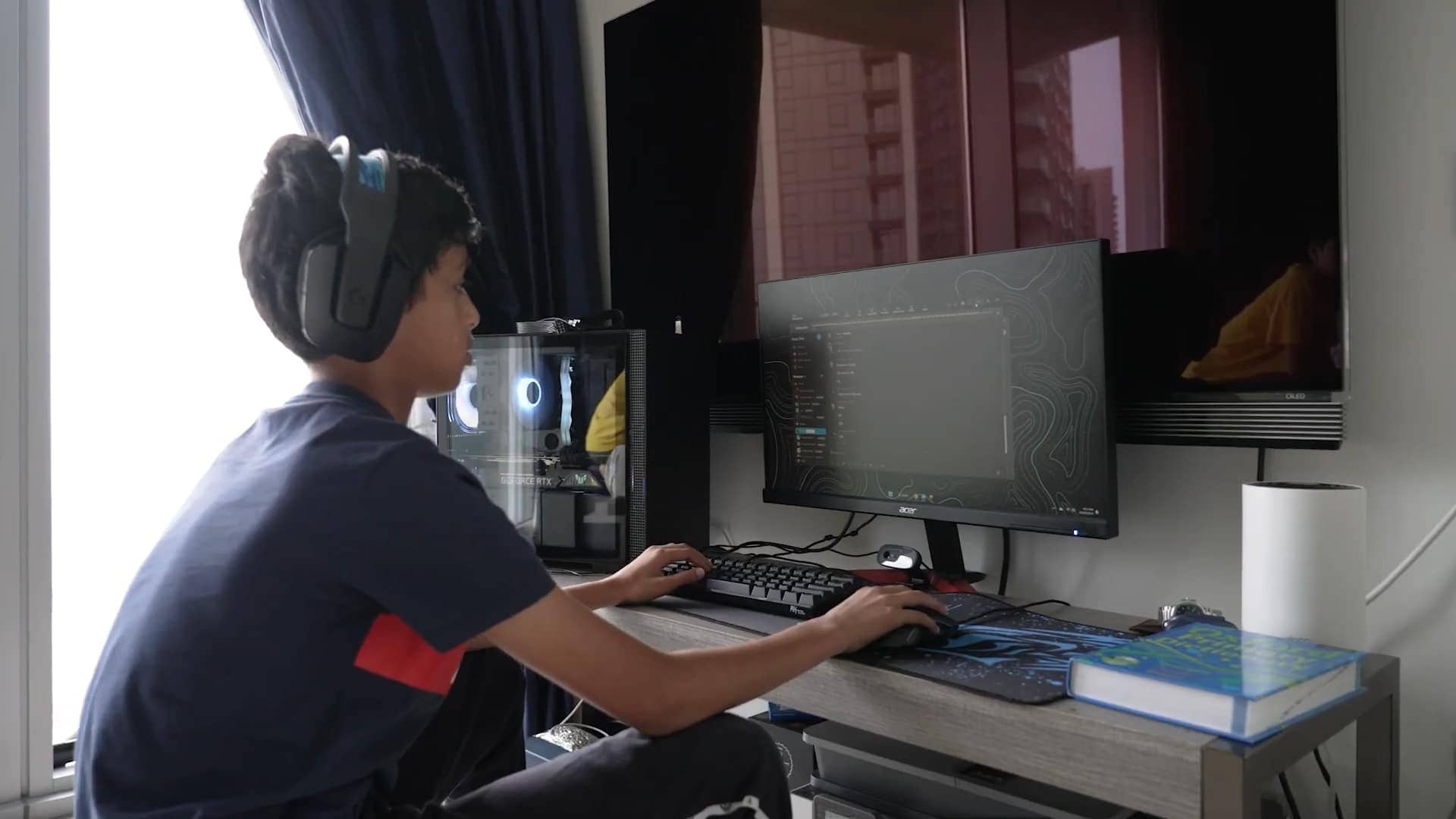 Teen boy using gaming and creative technology setup, modern computer, online learning, esports, student at home.