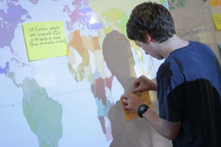 Global student engaged in interactive world map activity at a international school.