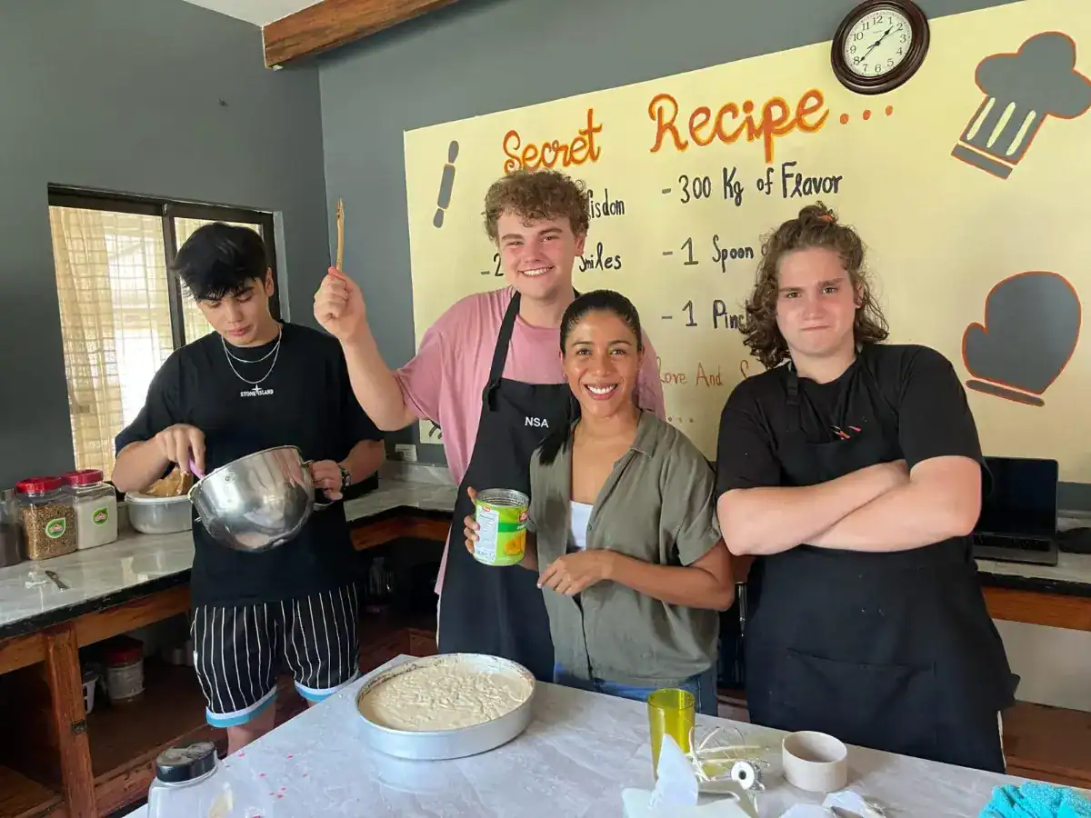 Young students participating in a cooking class at a world school, demonstrating hands-on learning and global education values.
