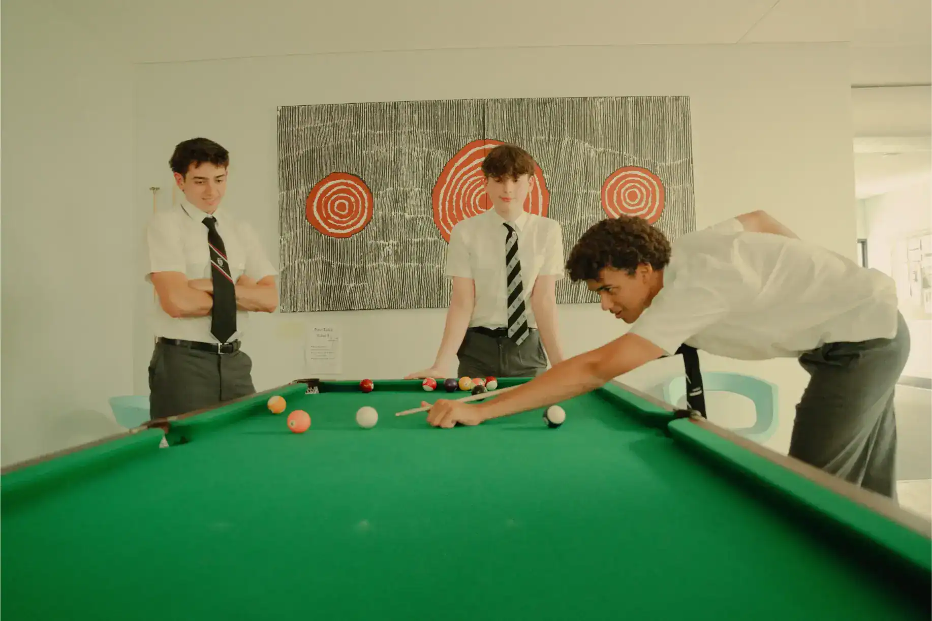 Bright students playing billiards at World Schools; promoting extracurricular activities and student engagement.