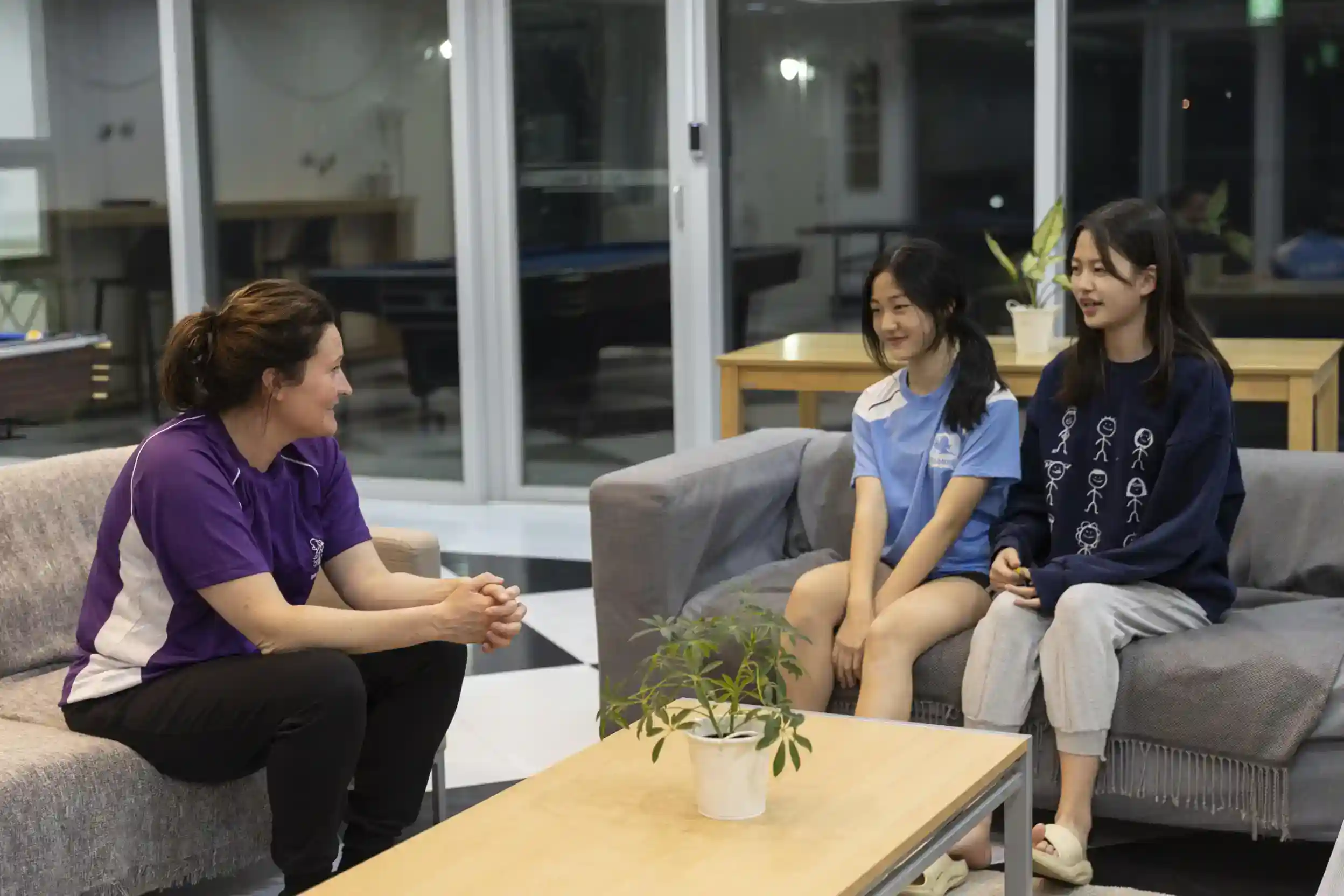 Focused teacher engaging with diverse students in a supportive school environment.